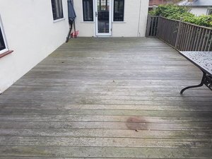 Wooden deck with patio furniture and railing