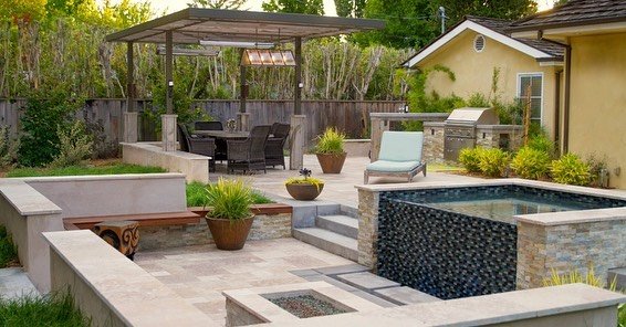 &bull;
You can pack a lot in smaller spaces with a well thought out design. 

Multifunctional elements, custom features and smooth transitions between spaces. 

This custom spa is easy to access from the upper level and a beautiful water feature from
