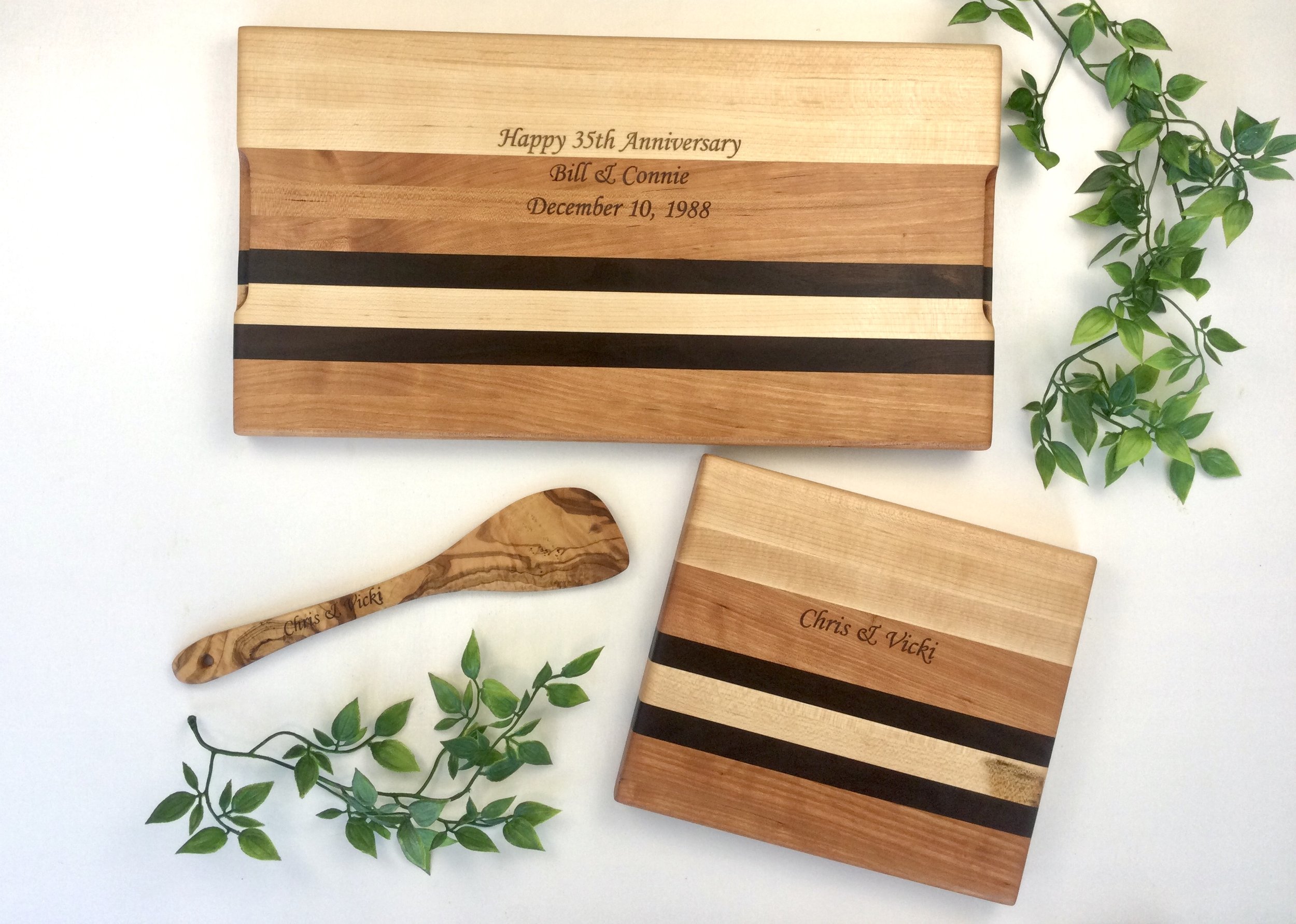We created these two matching cutting boards as a custom wedding anniversary gift for a client. We engraved the backs of the cutting boards and the handle of a spatula with a personalized message.