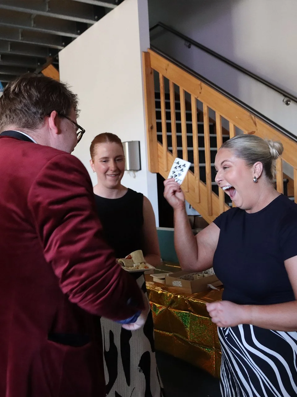 Josh Staley performing close-up roving magic for shocked guests at a private house birthday party in Melbourne.
