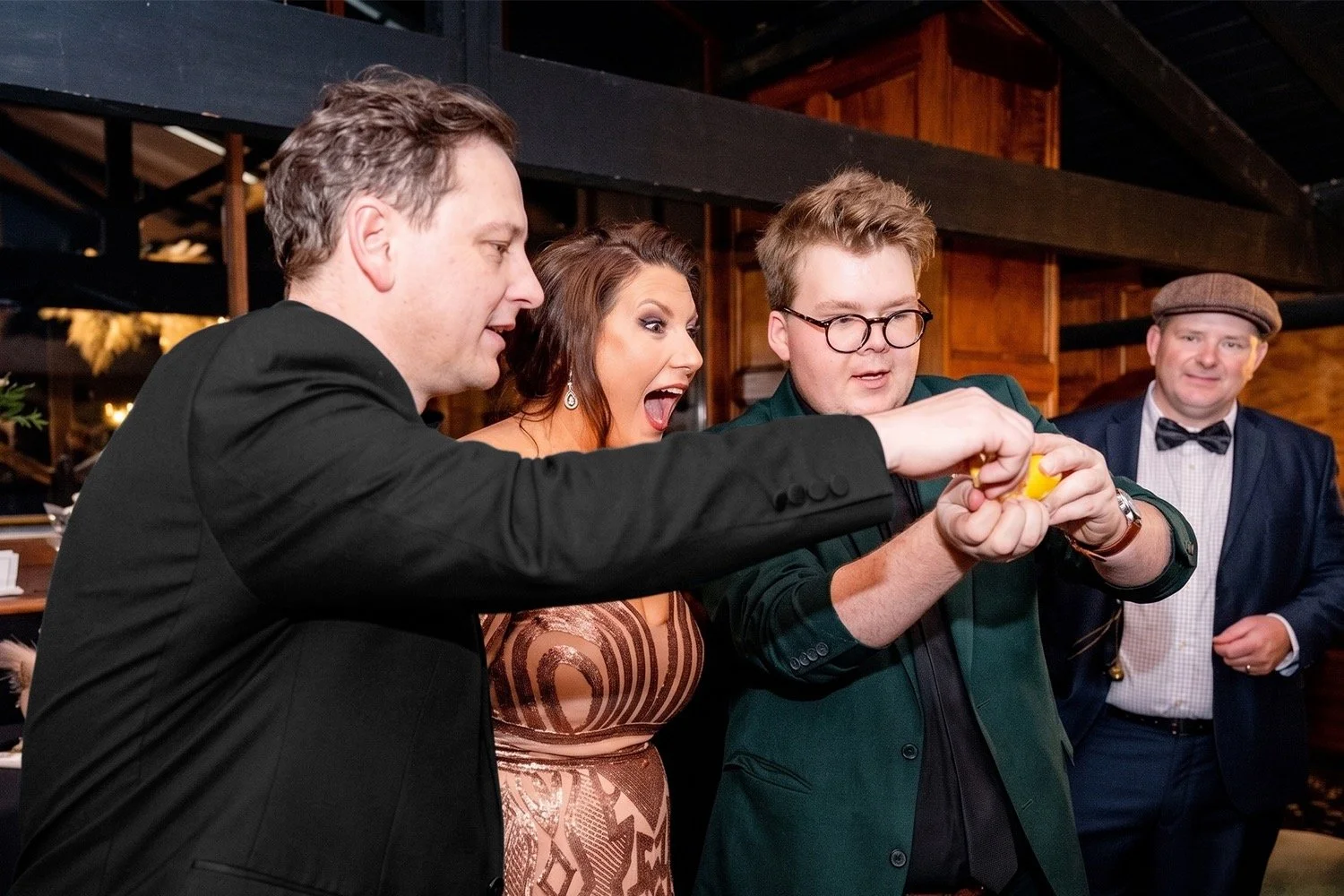 Josh Staley performing close-up roving magic for corporate guests during a cocktail hour in Melbourne.