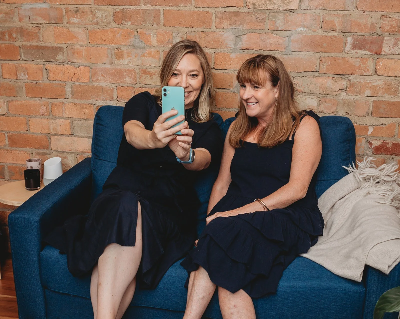 Claire Hewitt of Well Communications showing a client social media on smart phone