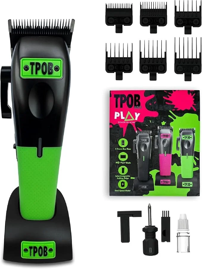 A black and green electric hair clipper with a charging stand, multiple clipper blades, additional attachment blades, and accessories including a T-shaped tool, oil bottle, and cleaning brush.
