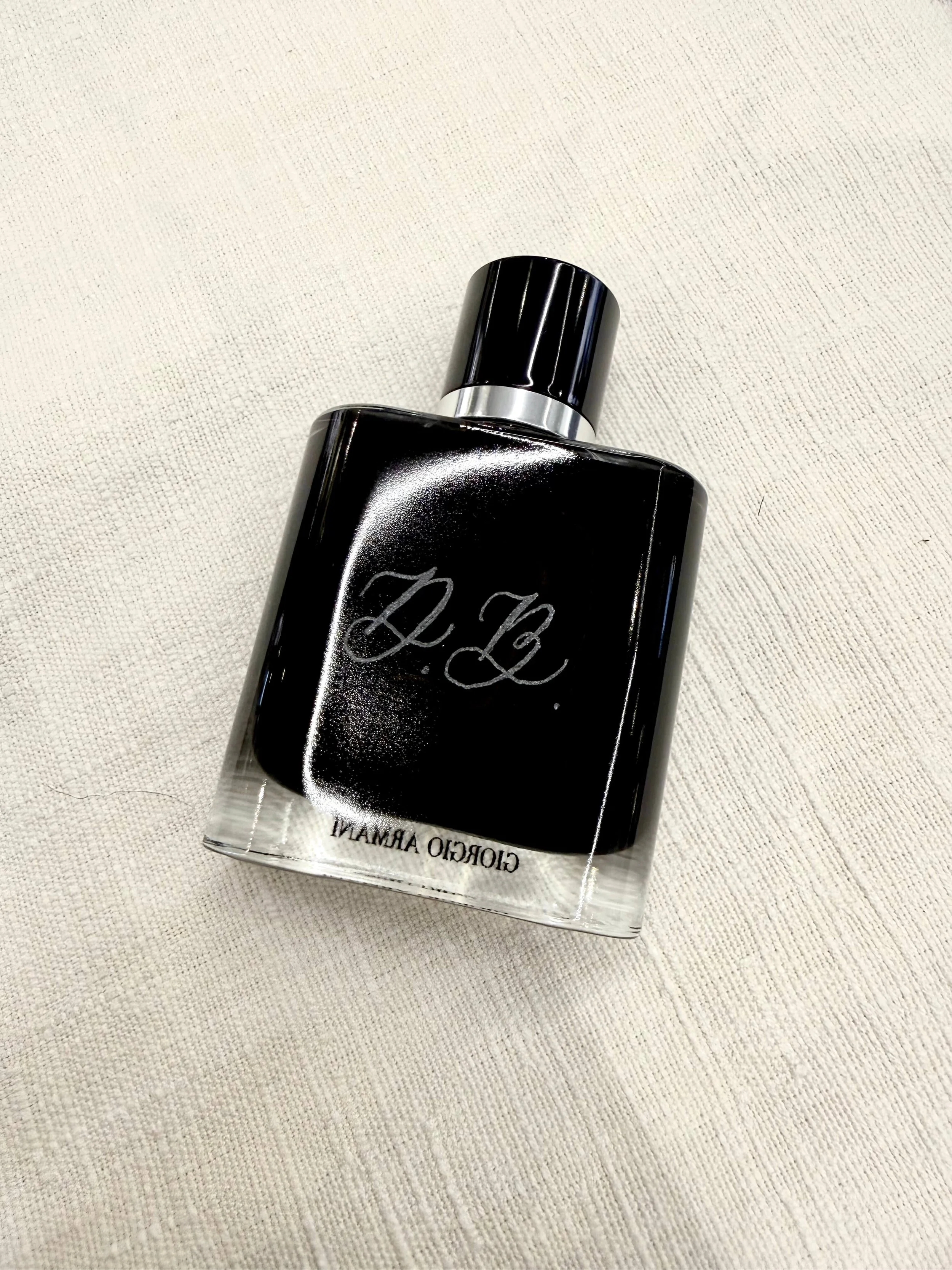 Hand-engraved custom monogram initials on a Giorgio Armani luxury cologne bottle for corporate gifting in Northern California