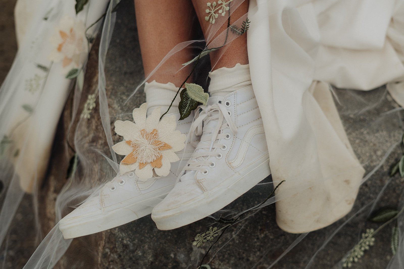 Close up of Brides shoes with flower veil