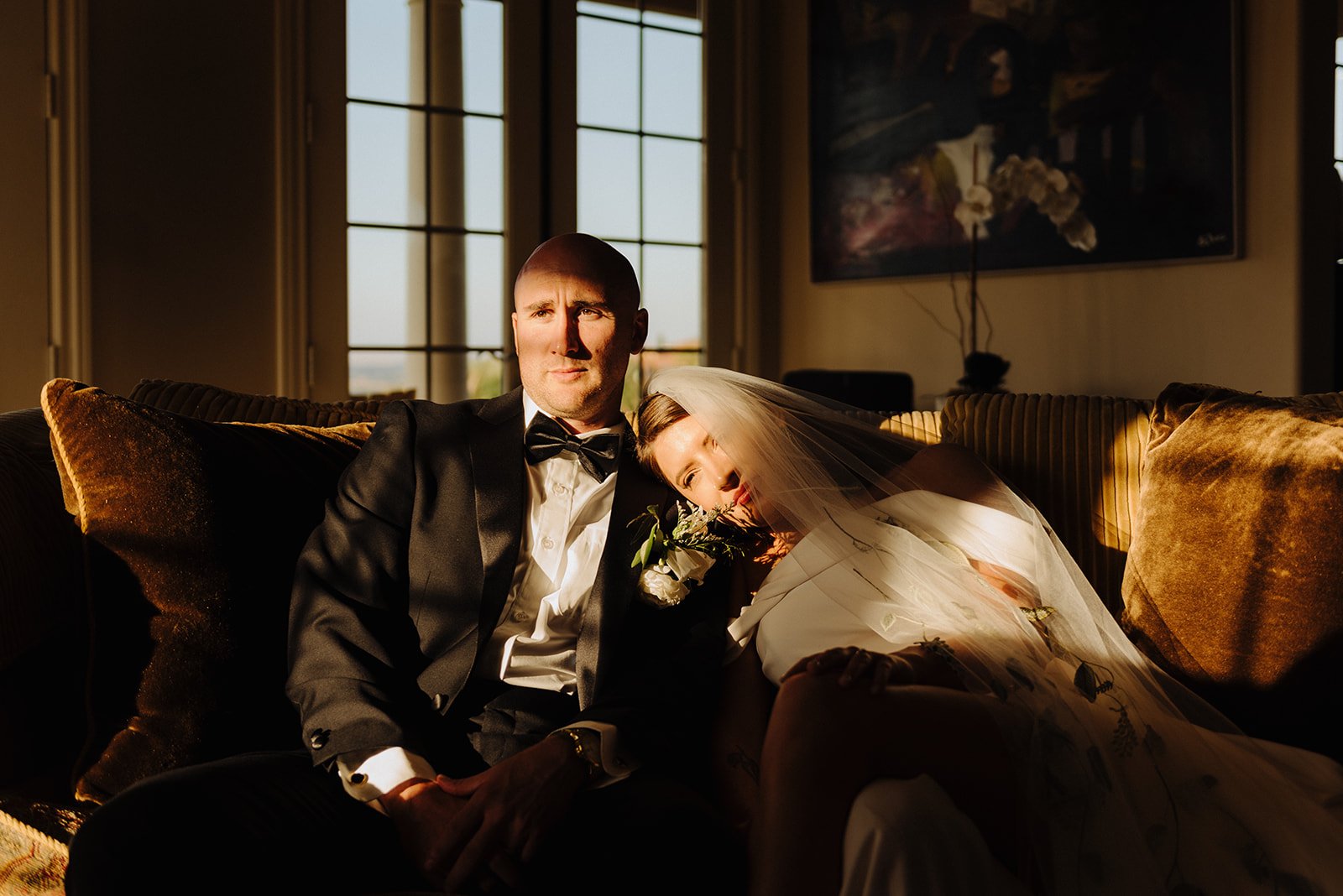 Bride and groom sitting together in the sunlight