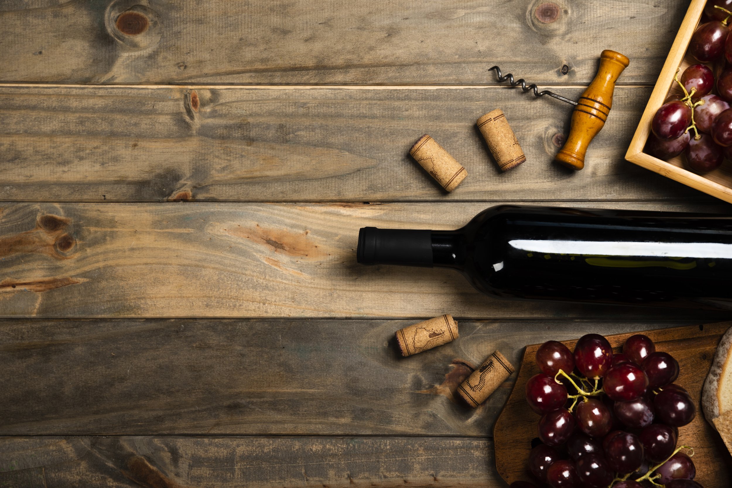 flat-lay-bottle-wine-surrounded-by-corks-red-grapes.jpg