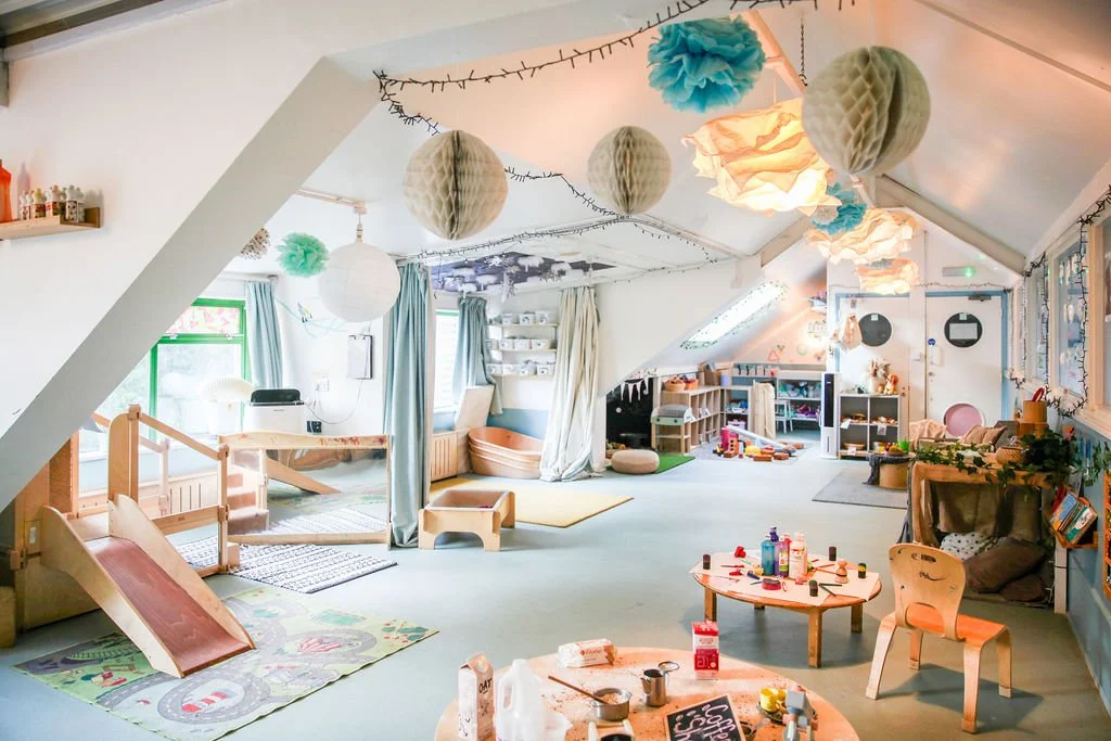 Nursery practitioner at Raised in Bristol nursery teaching a child about movement