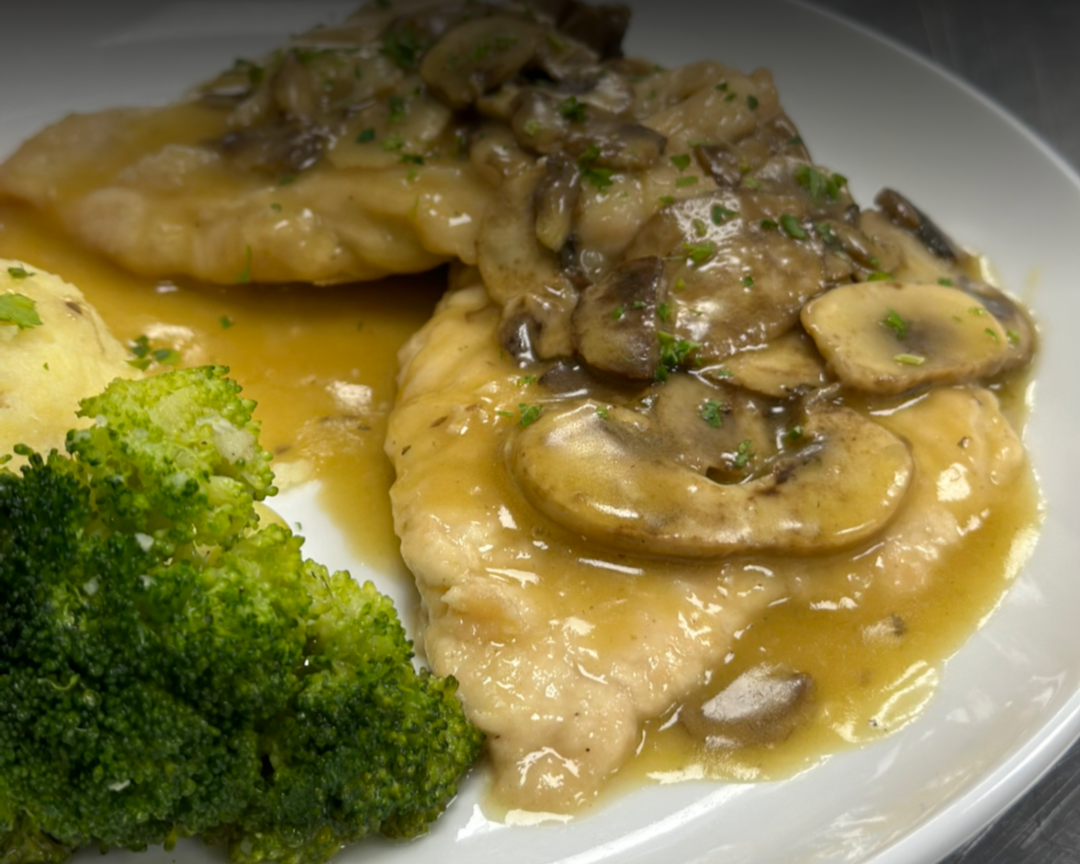 Chicken breast topped with mushroom gravy, served with broccoli and mashed potatoes.