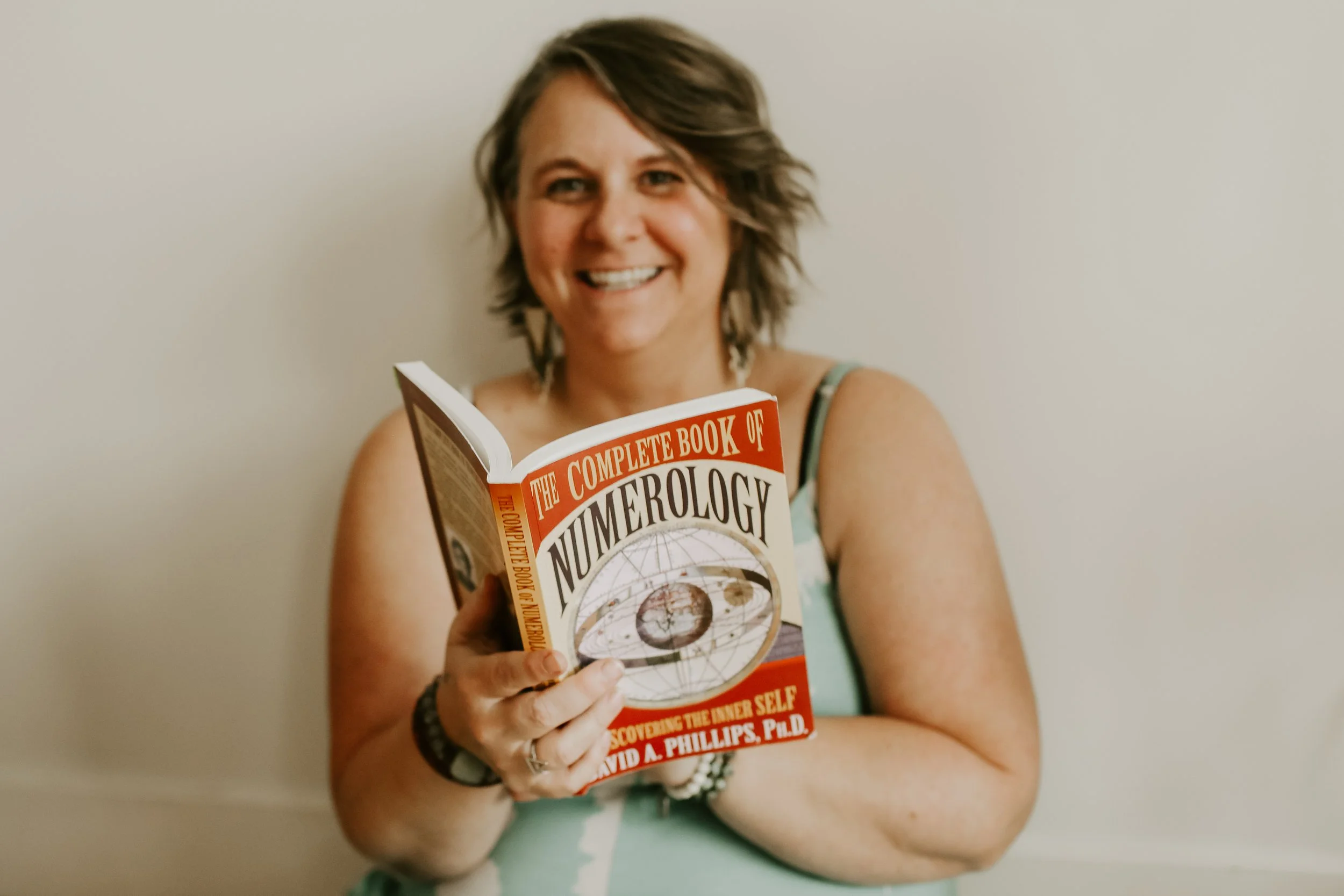 woman reading her numerology book learning is constant