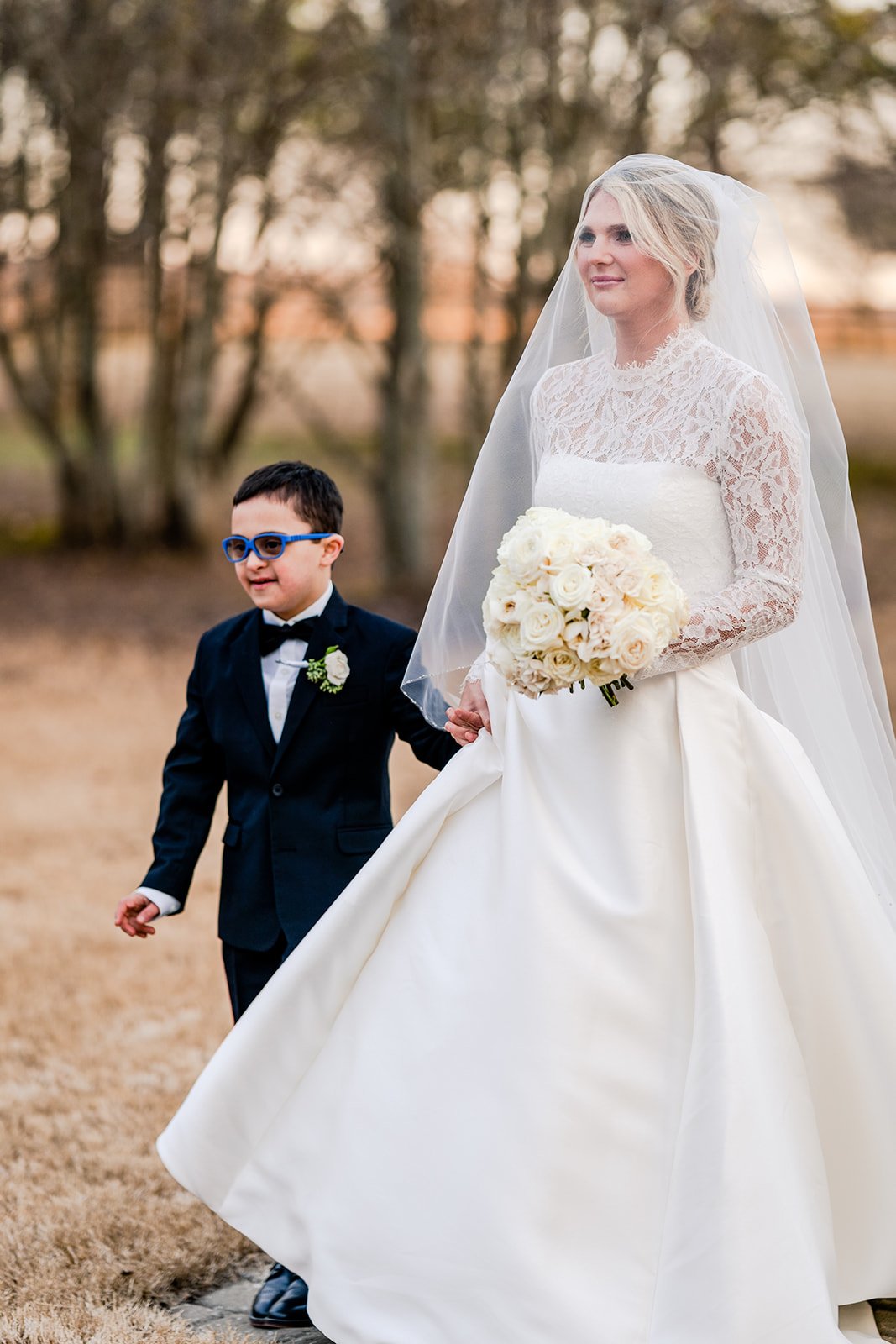 groom's son escorts bride down the aisle