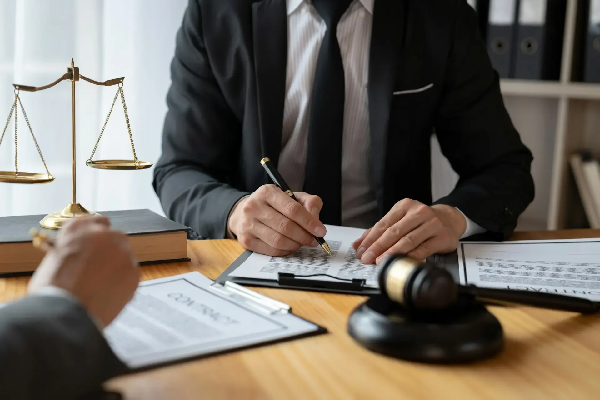 Asset protection lawyer reviewing Series LLC and real estate documents to prevent fraudulent transfers and defend creditor rights.
