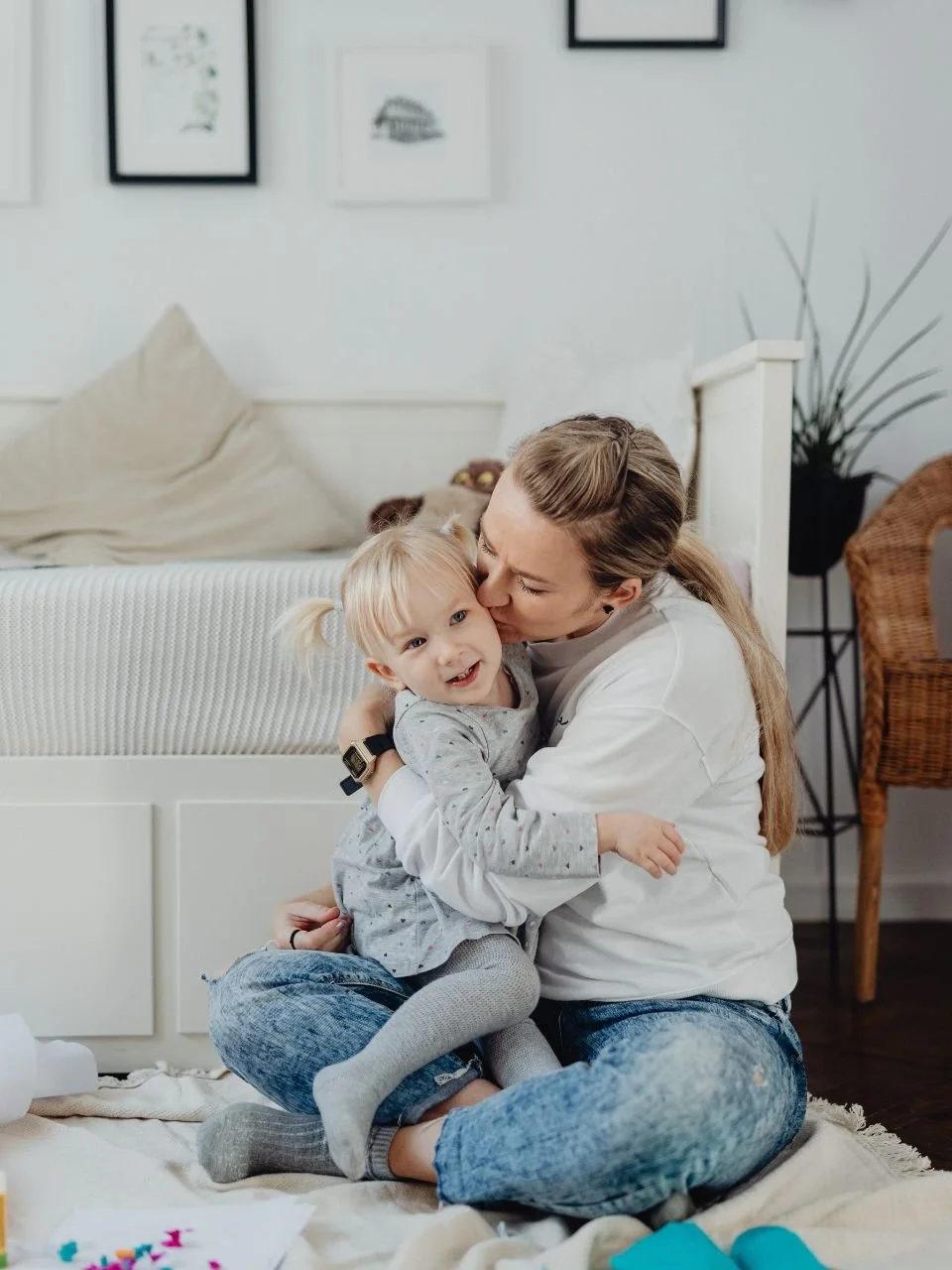 Mother hugging her young daughter at home