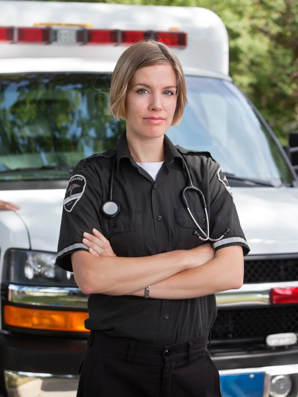 Paramedic standing in front of an ambulance