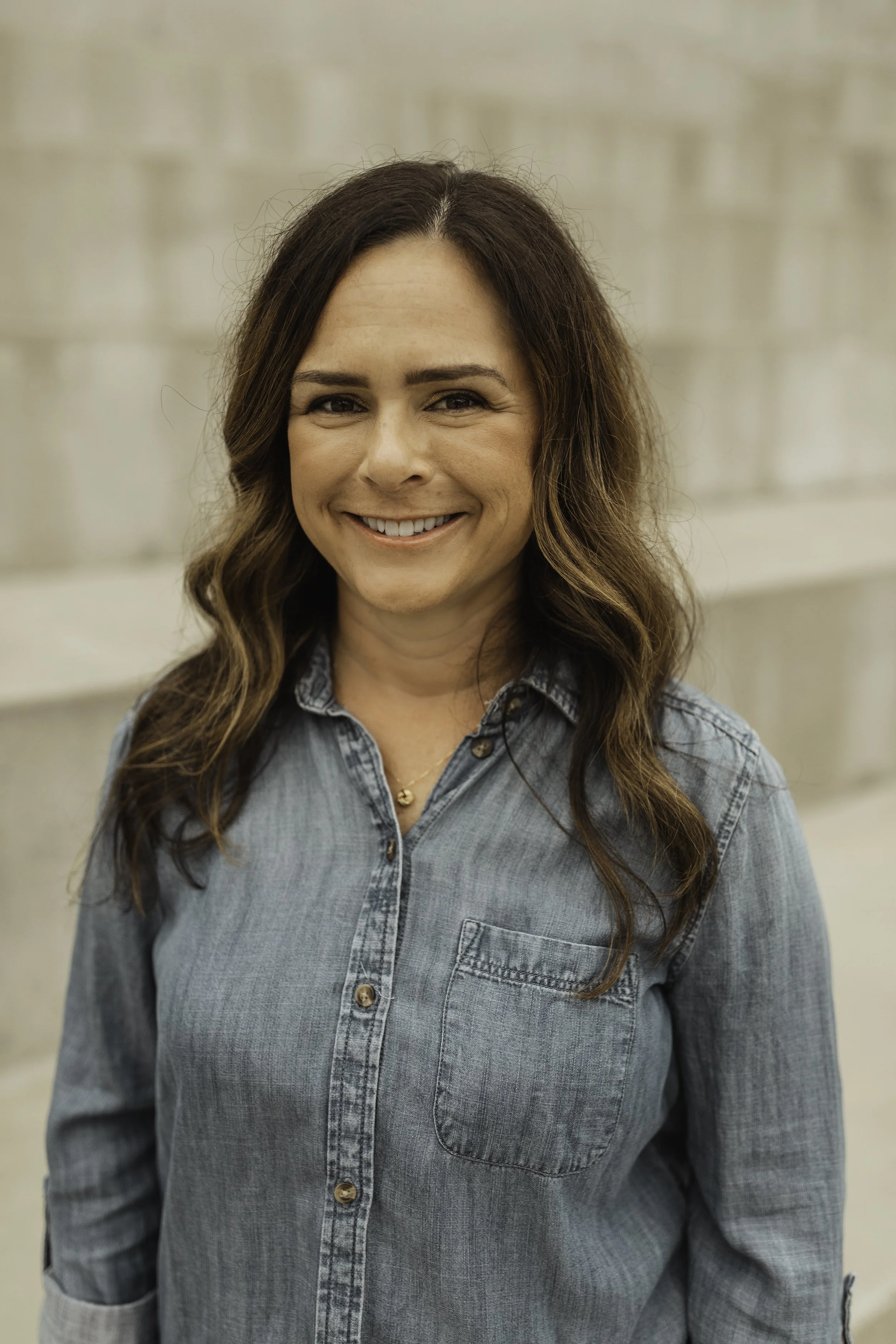 Jill Boyle, LMFT, smiling in a chambray shirt