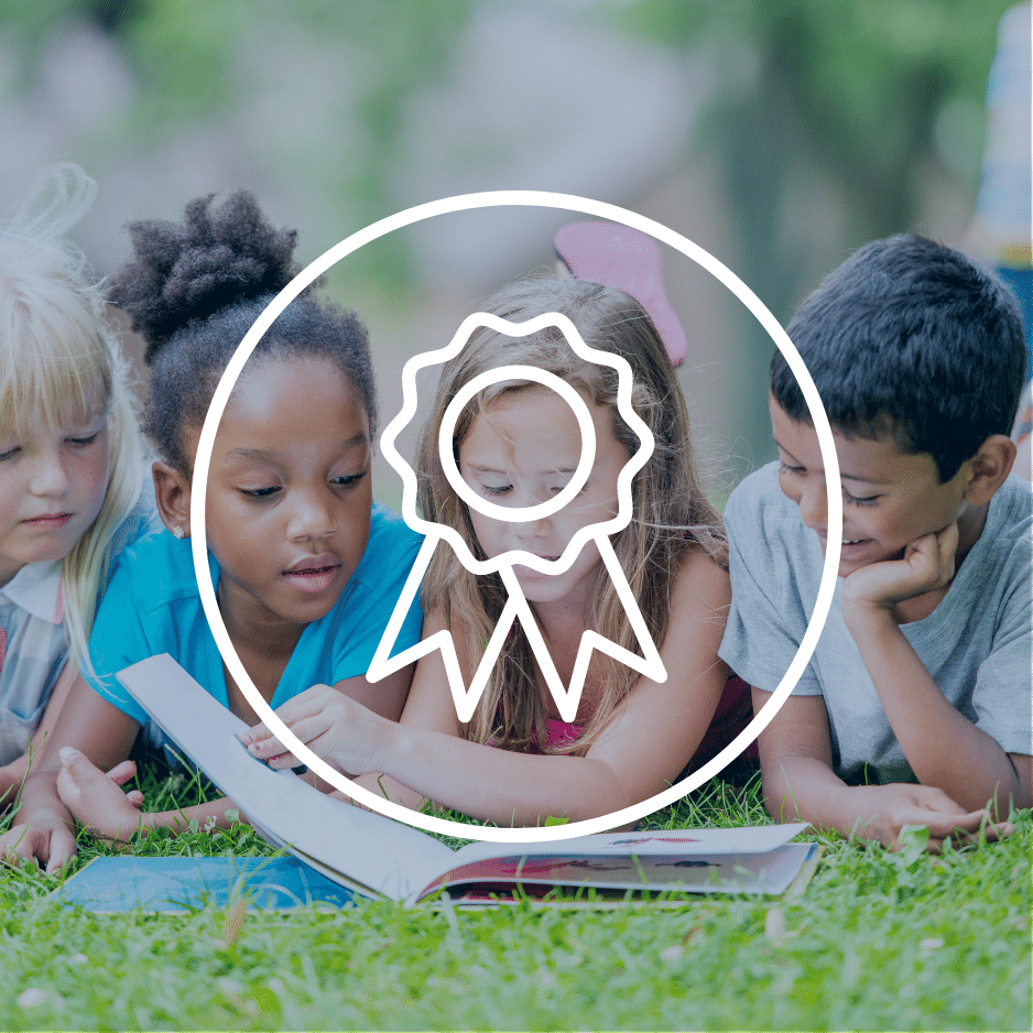 Young children reading a picture story book for the YABBA Awards.