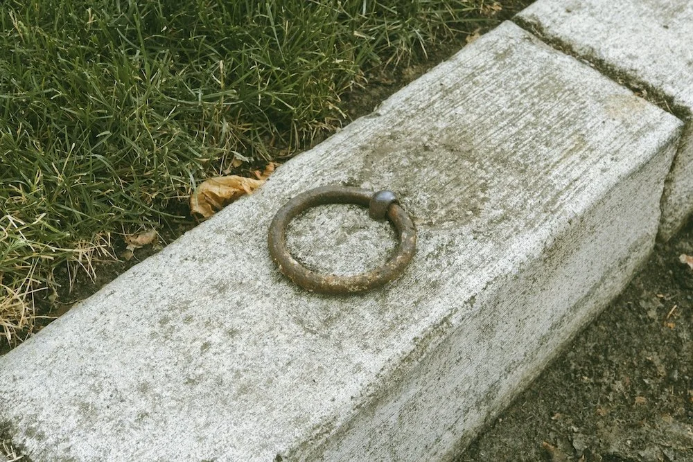 Sidewalk horse rings in Portland Heights.