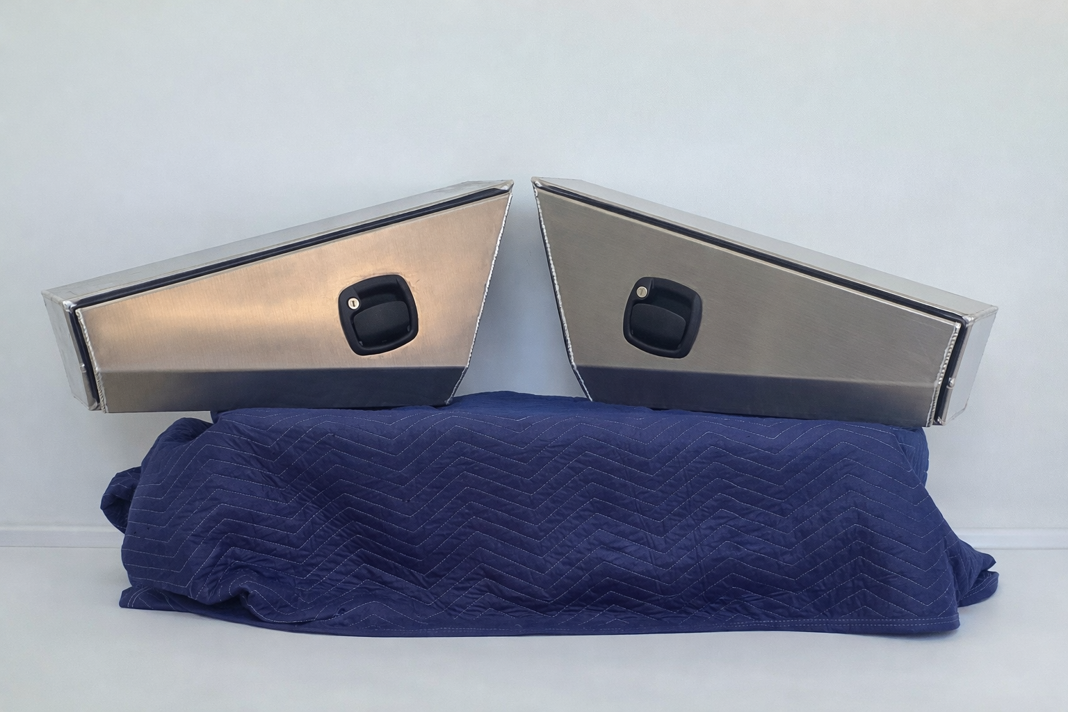 Symmetrical aluminum storage boxes on blanket.png