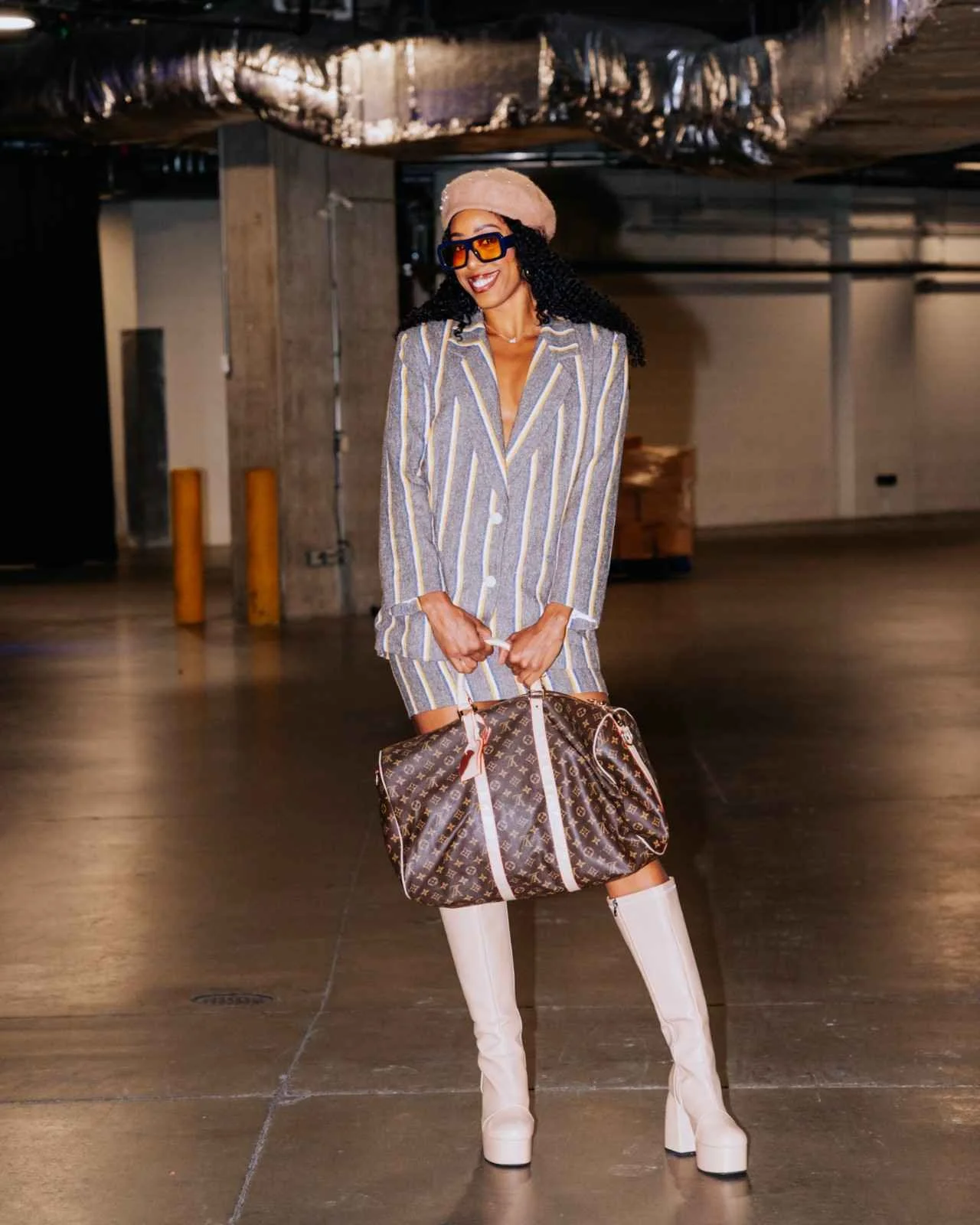 Editorial WNBA tunnel fashion look with coordinated tailoring and statement boots