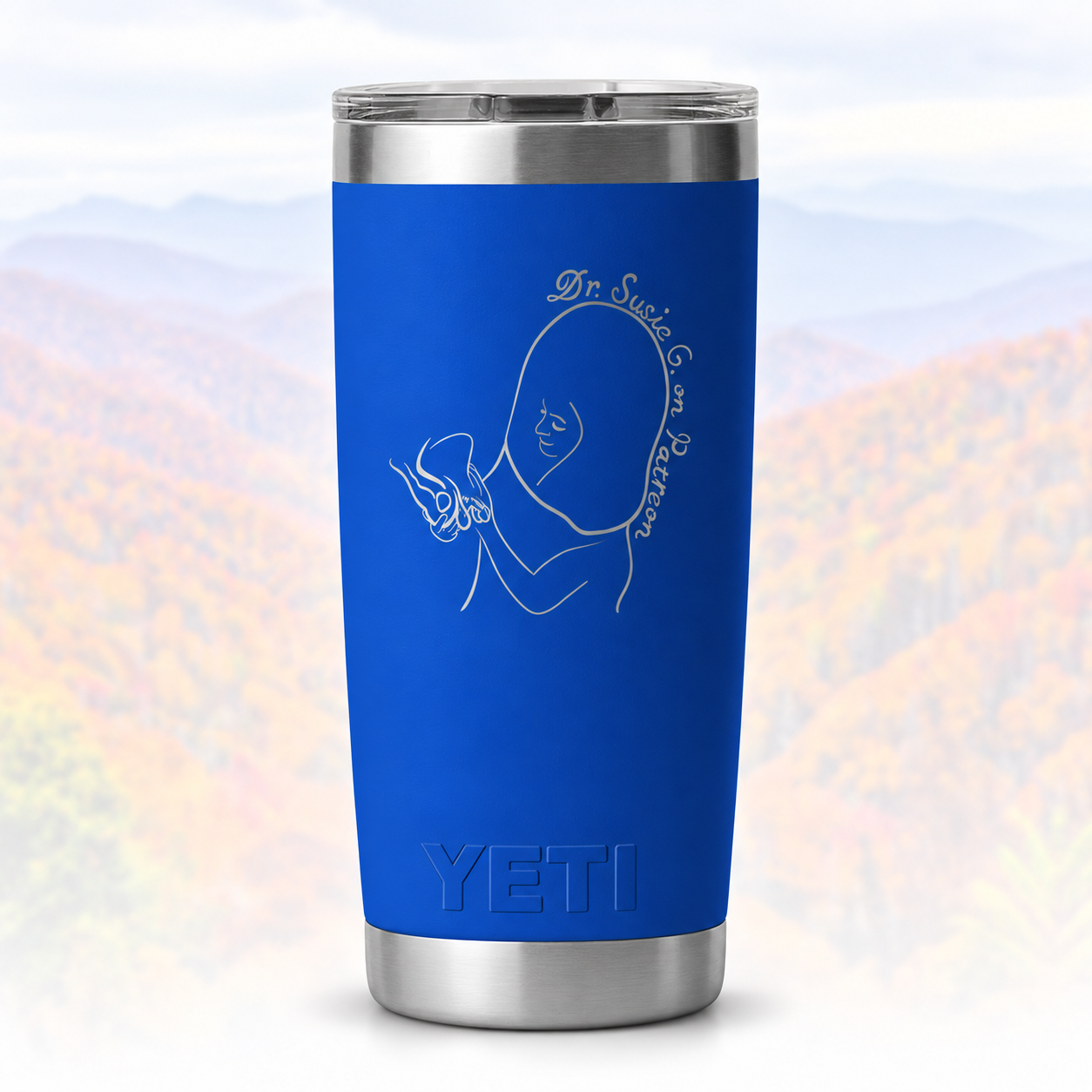 Blue YETI tumbler over faded mountains.png