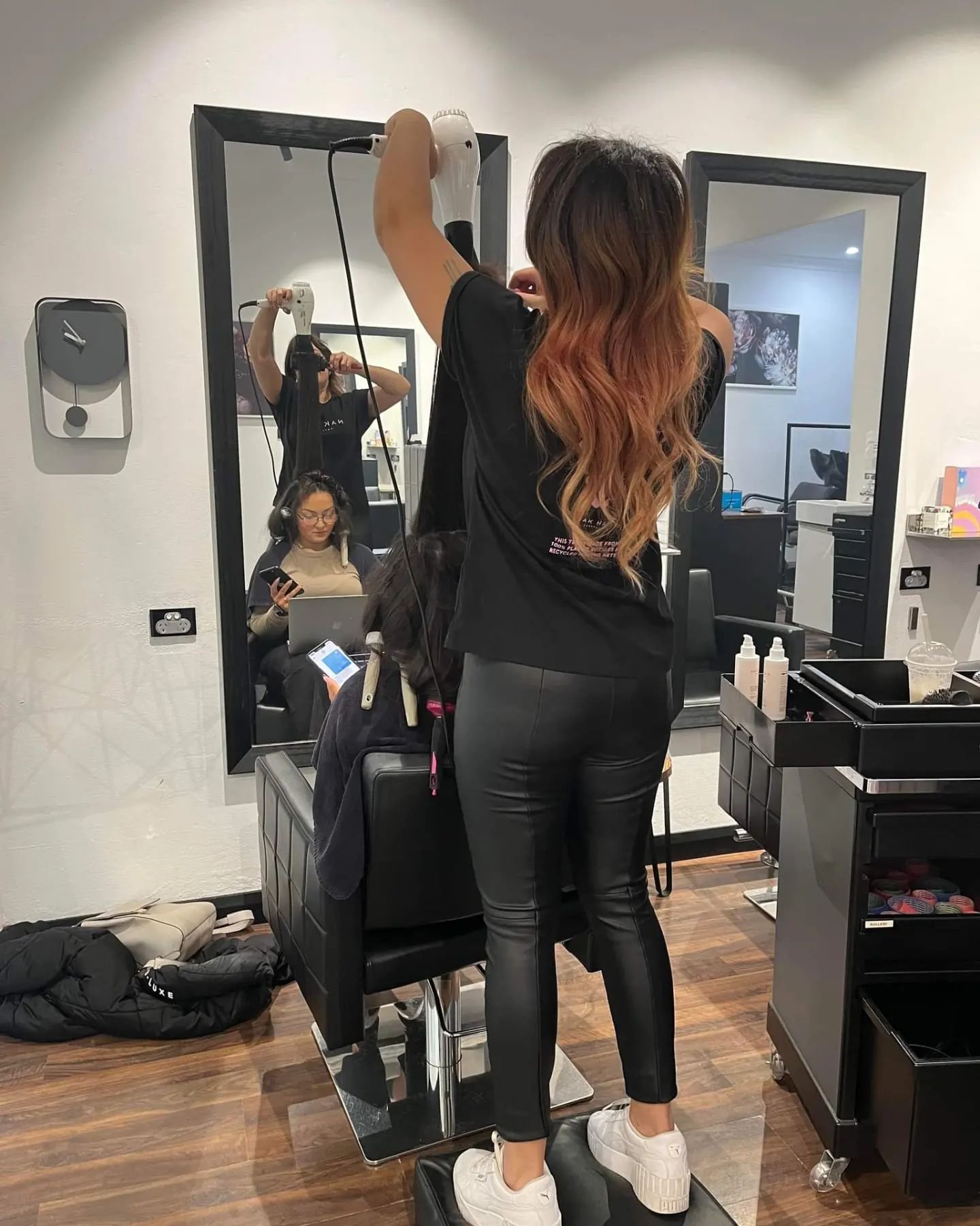 Owner Ash from Boab Haor Art Sutherland blowdrying a customer's hair.