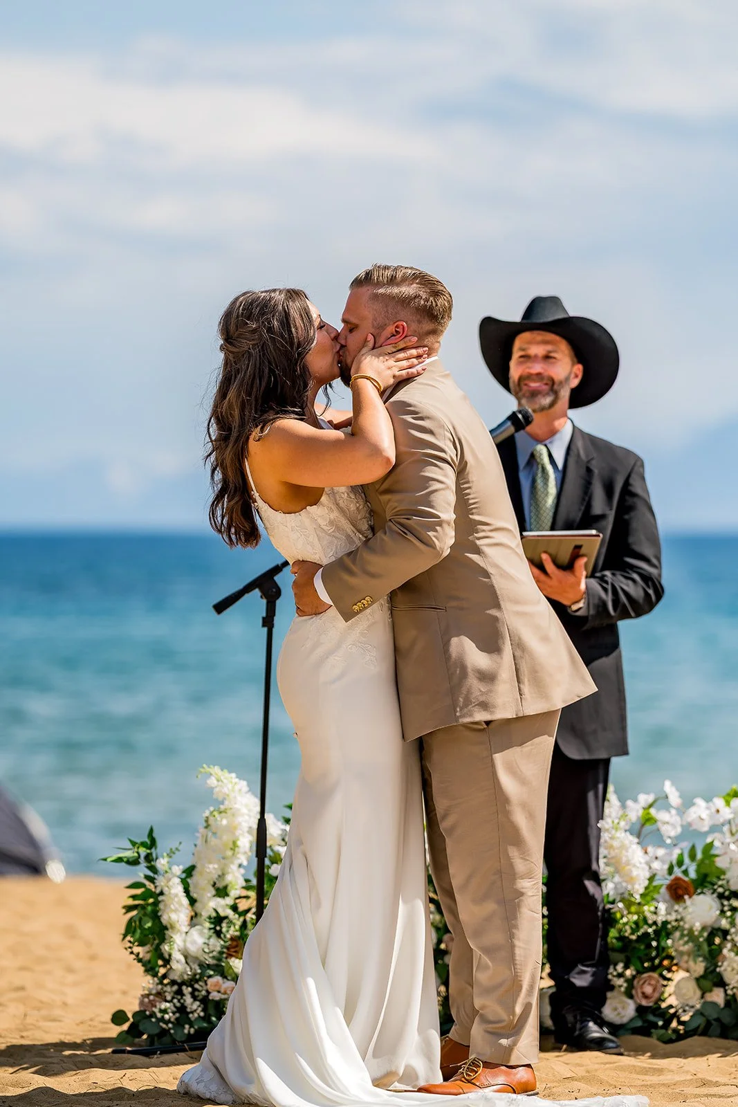  A bride and groom kiss with Lake Tahoe in the background at the North Tahoe Event Center in Kings  Beach, California. 