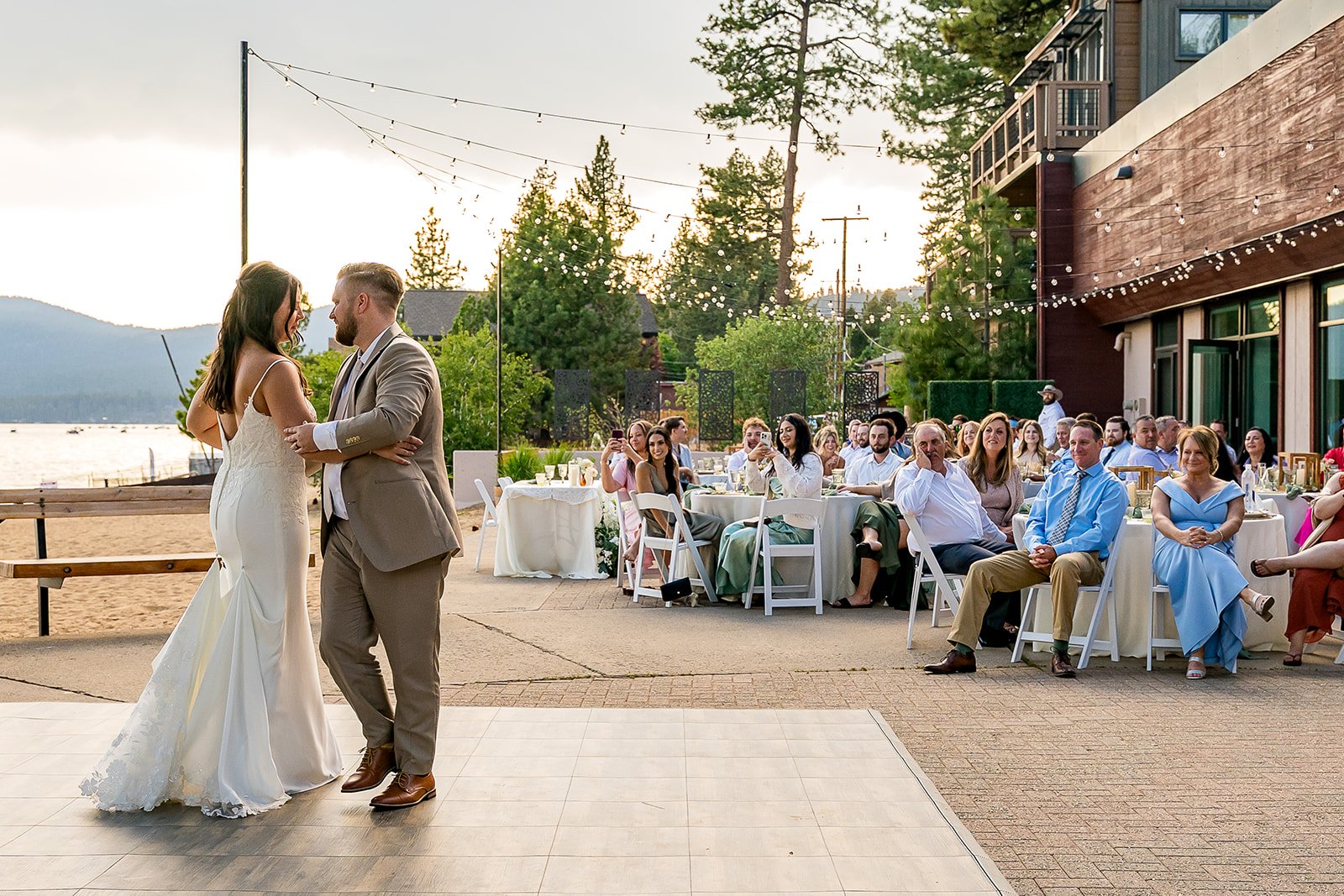  A bride and groom share their first dance as their guest watch with Lake Tahoe in the background at the North Tahoe Event Center in Kings  Beach, California. 
