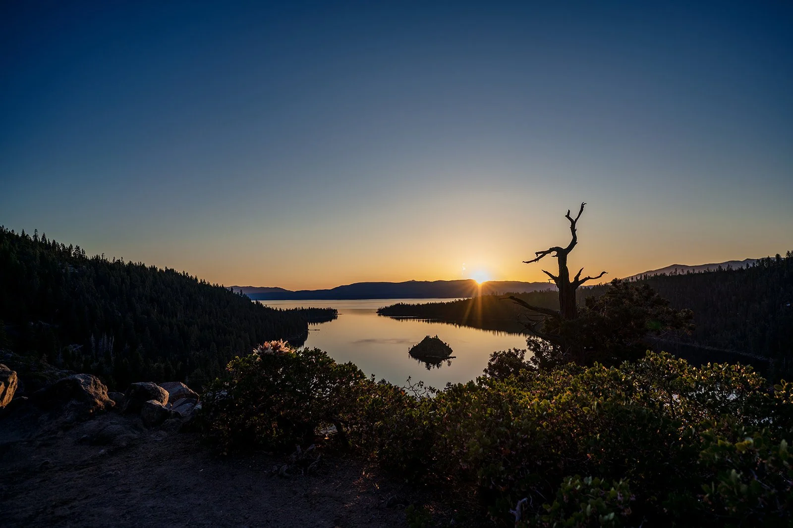 The sun rises behind Lake Tahoe and Emerald Bay photographed by Lake Tahoe wedding photographer Nicky Byrnes Photography
