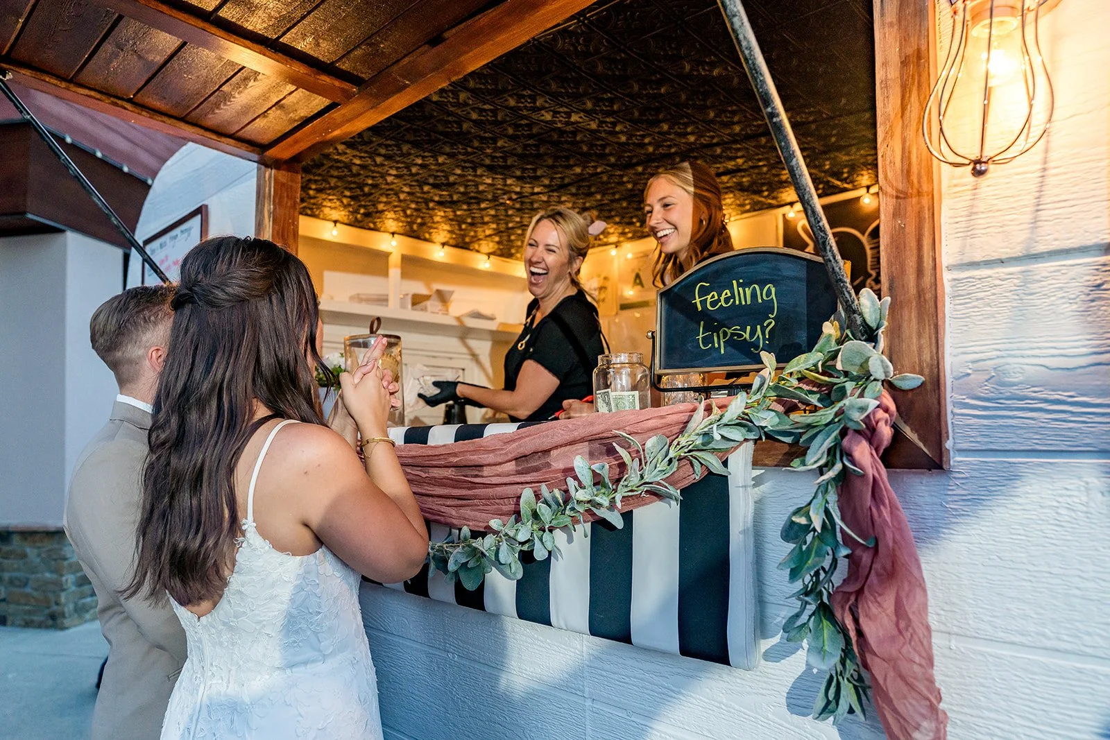Two women laugh as they greet a bride and groom at the North Tahoe Events Center in Kings Beach, California.