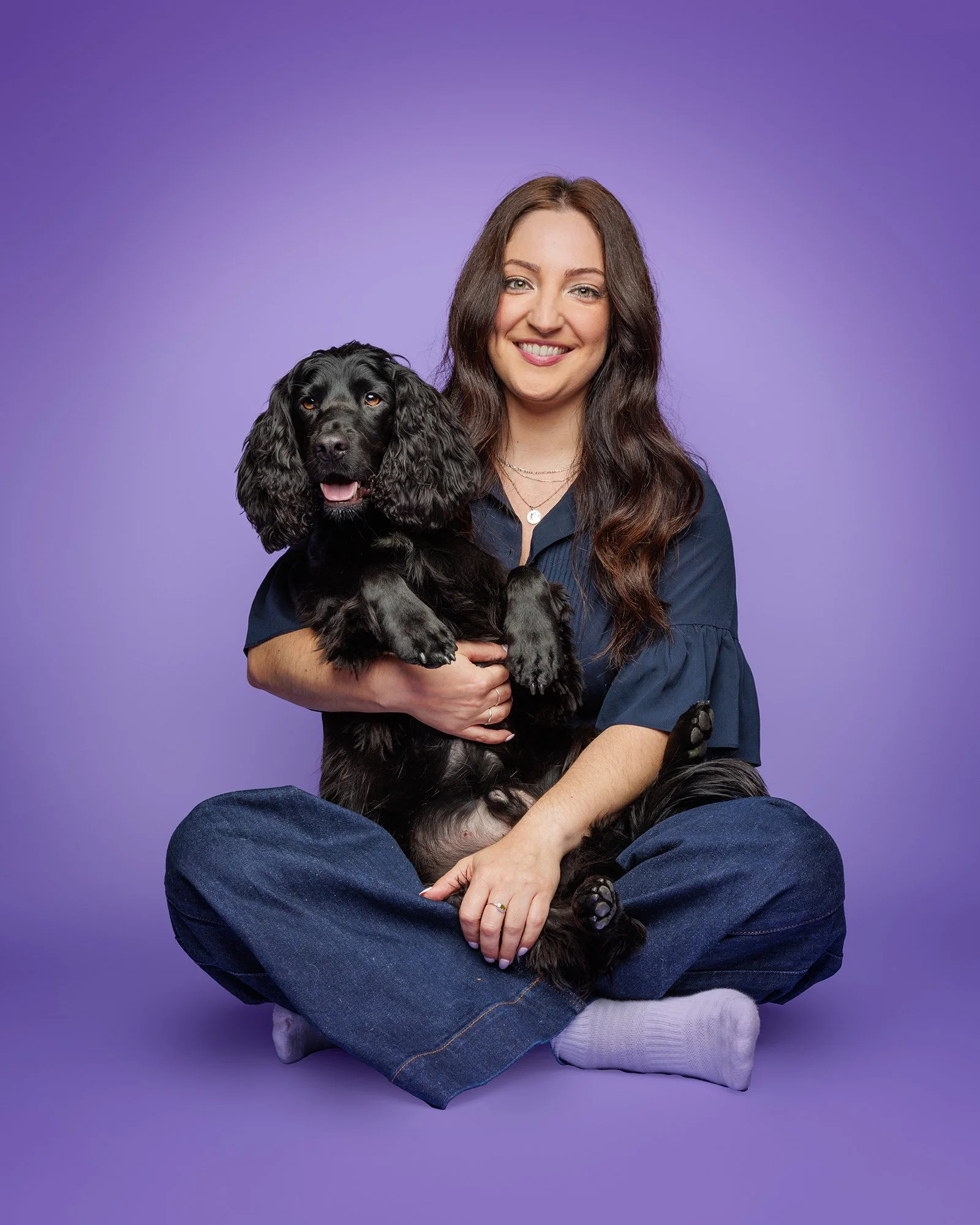 image of a cocker spaniel and his owner on a purple studio background with london dog photographer amie barron