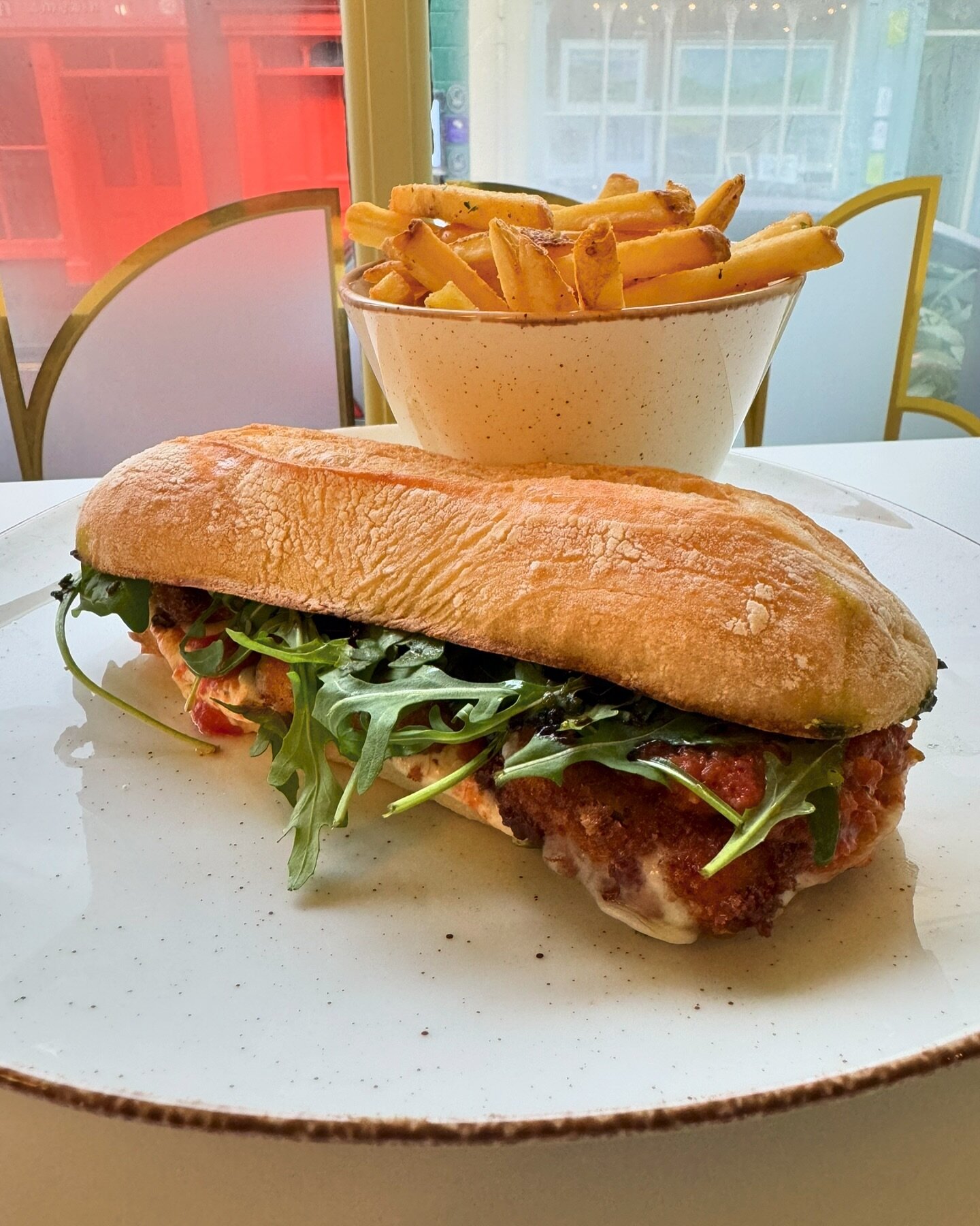 @krahsnori version of a cheese sandwich - fried mozzarella (iykyk), tomato sauce, garlic mayo, rocket, balsamic glaze, onions on ciabatta and fries 🍟 🧀 🥪