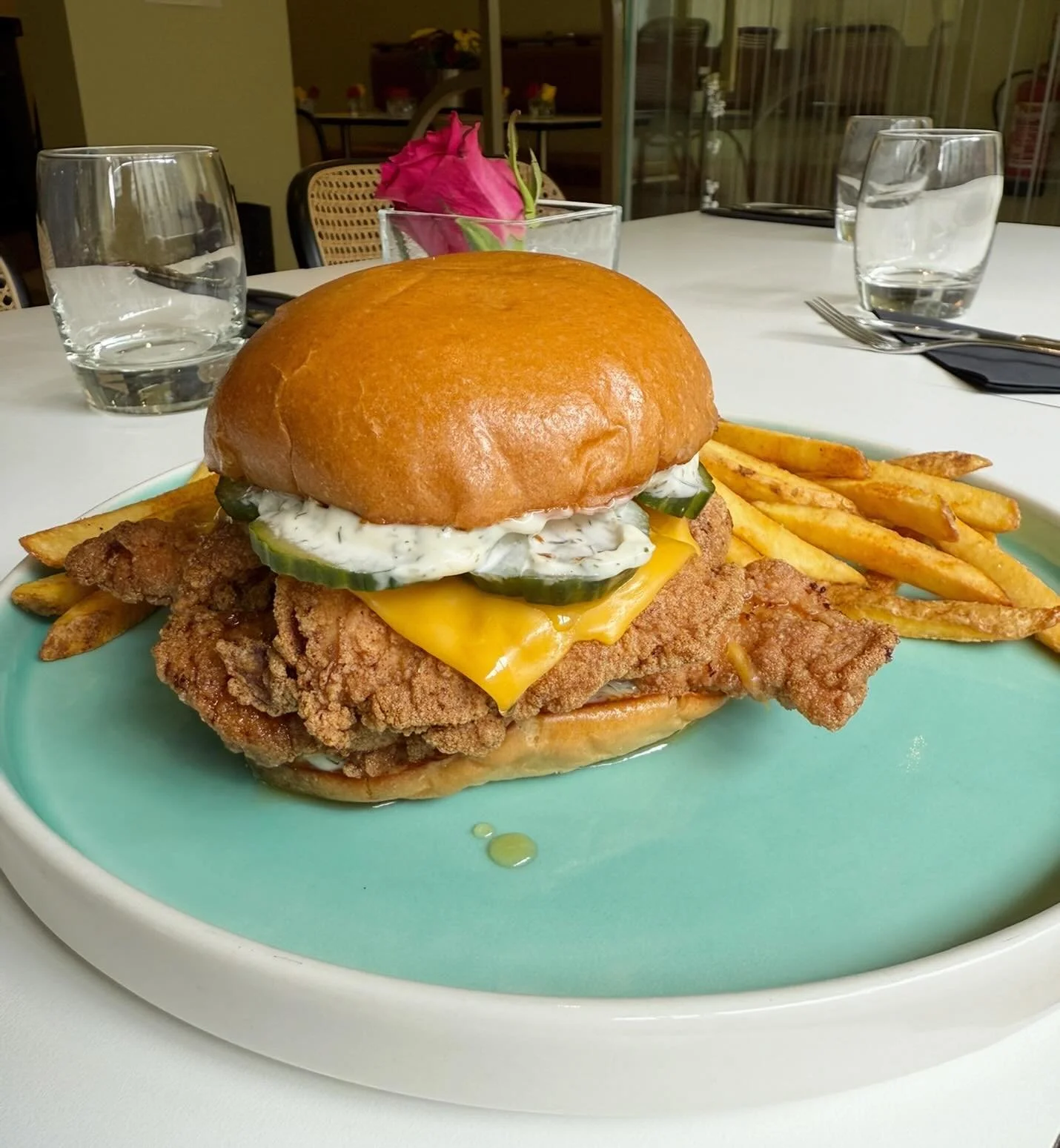 Fried chicken burger with hot honey, American cheese, spicy pickles + ranch on a brioche bun with fries 🍟 🍗 🍯
