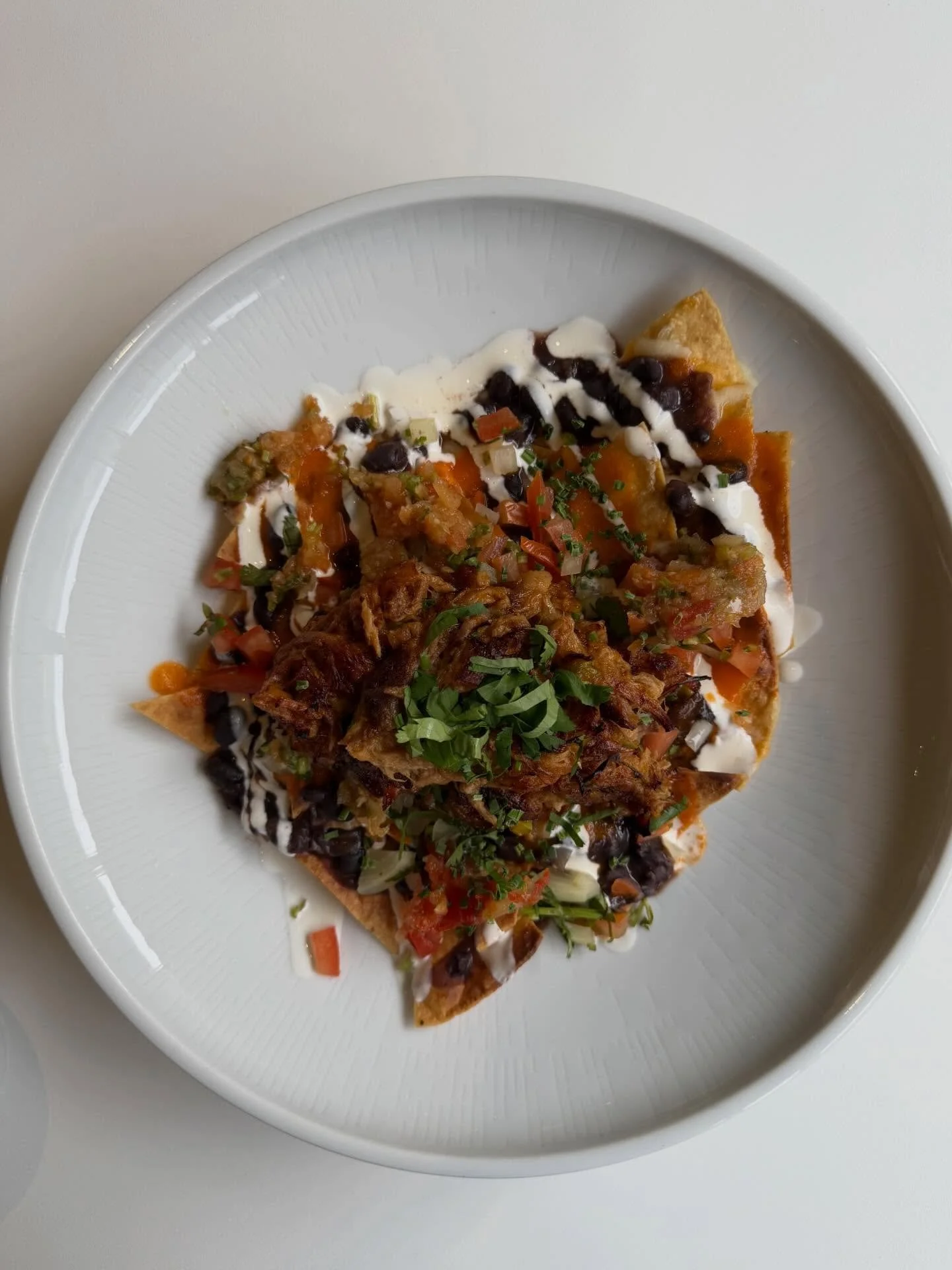 Pulled pork nachos with black beans, cheese, pico, crema, mozzarella + cheddar 🥰☺️