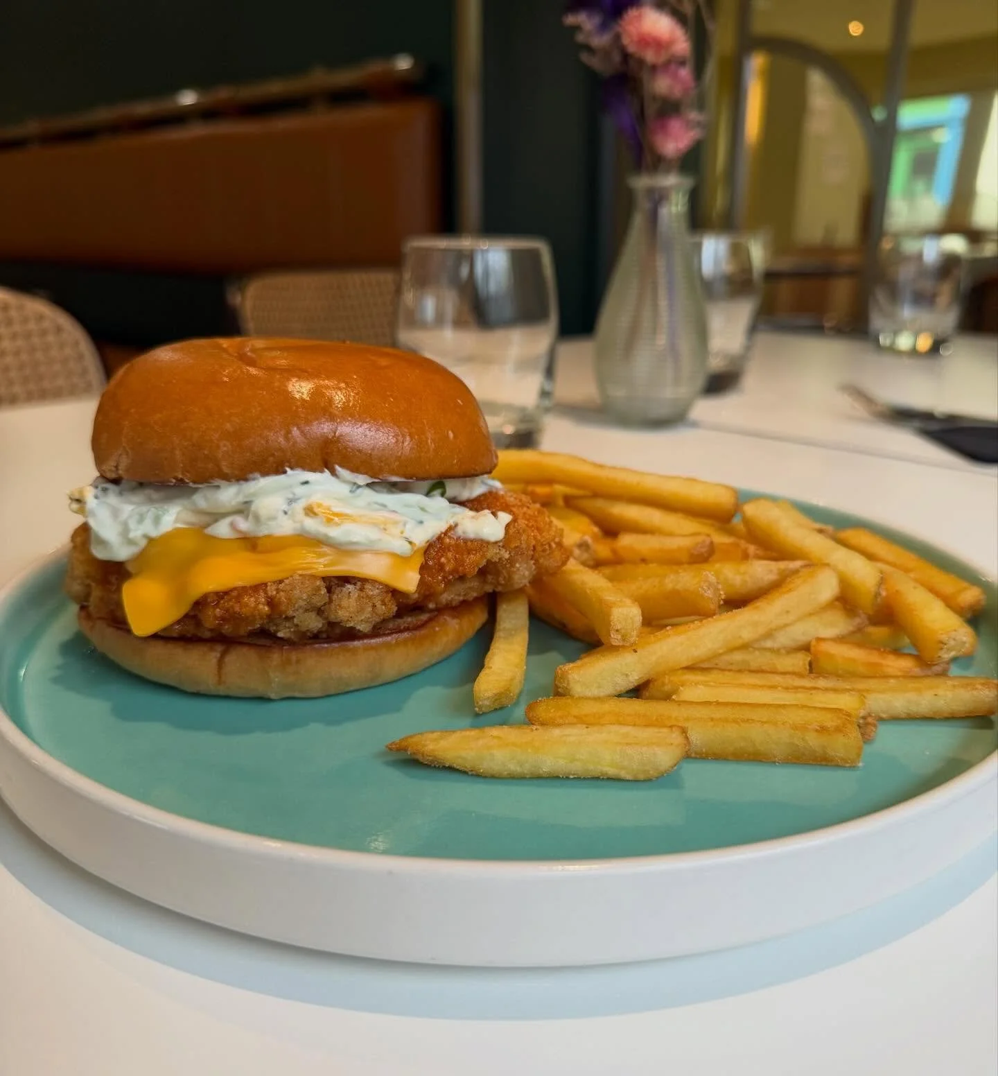 Buffalo Chicken Burger - crispy fried chicken breast, blue cheese schmear, Franks Red honey butter, american cheese on a brioche bun with fries 🍟 🍔 🍗