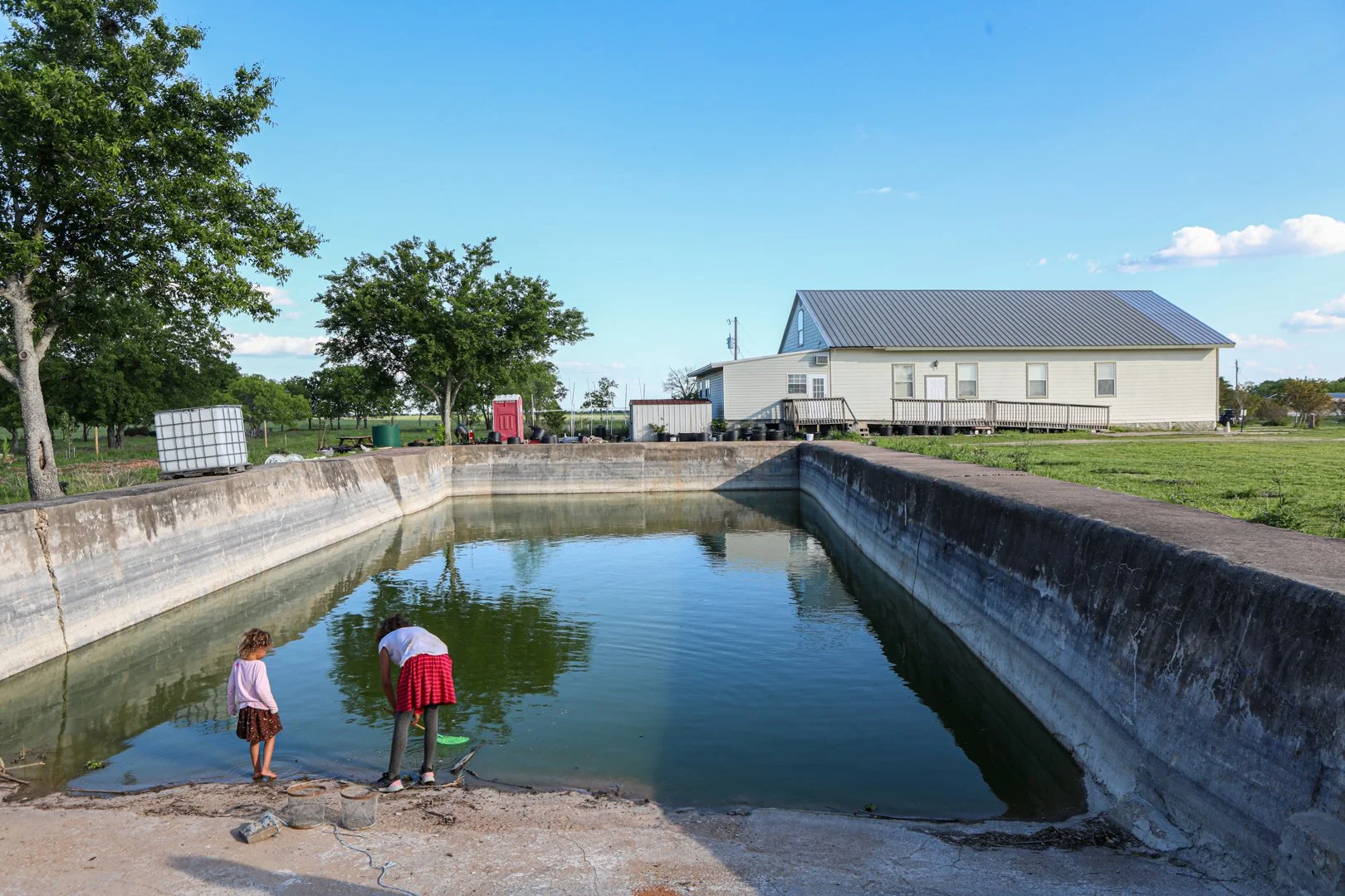 The children that live on the remains of the Branch Davidian compound play in what is left of the pool thirty years later.