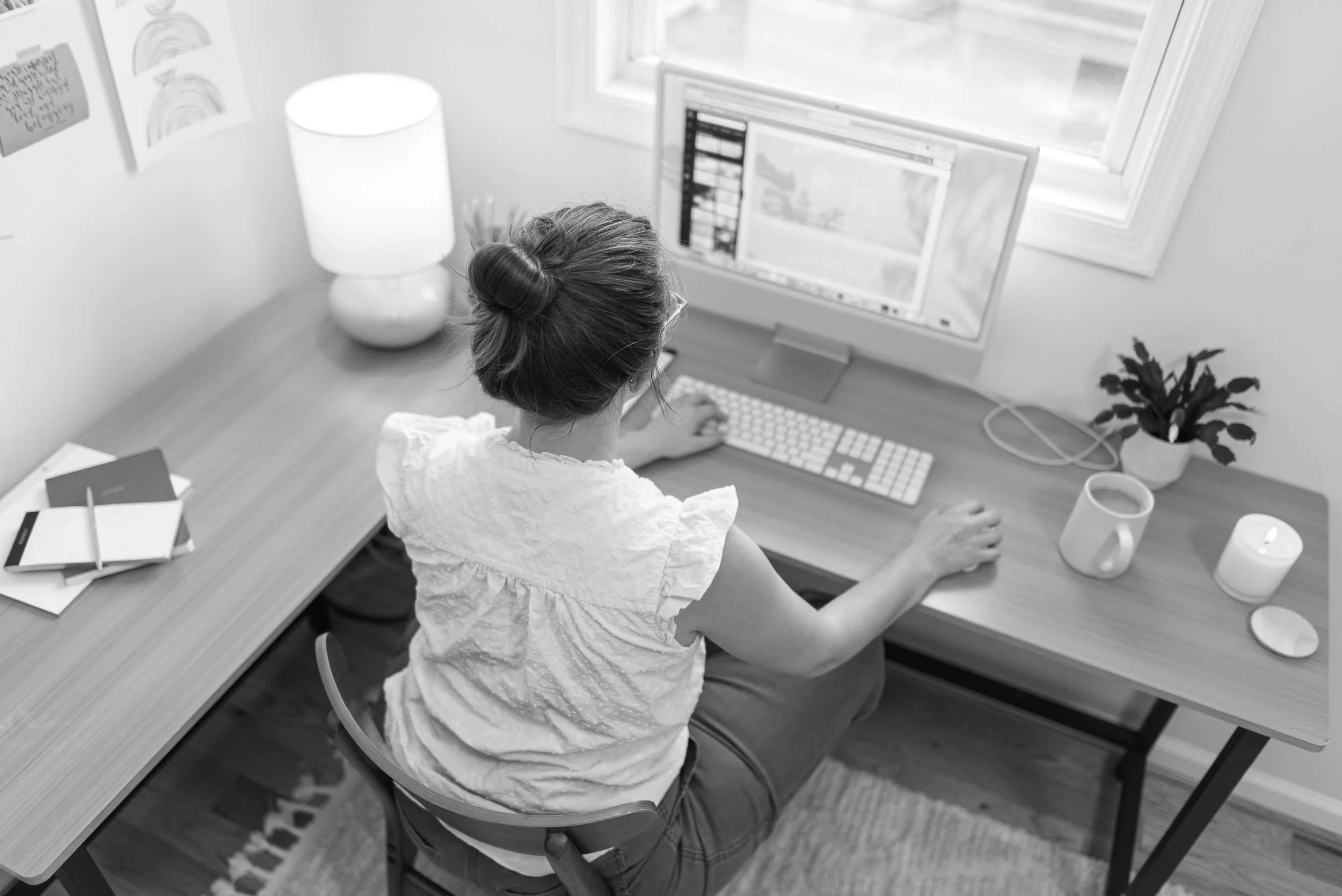 A pic of Ellie Miller working at her desk, who created squarespace templates and web design for therapists and coaches