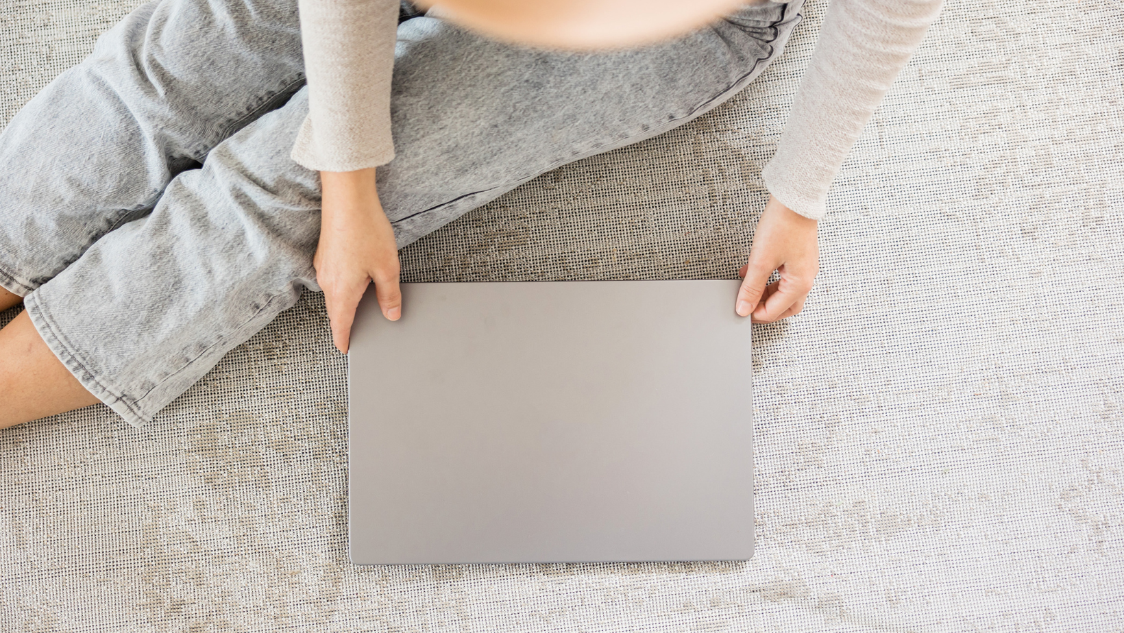 a pic of a woman holding a laptop to illustrate the work of Ellie Miller Design Co, squarespace templates and web design for therapists and coaches.