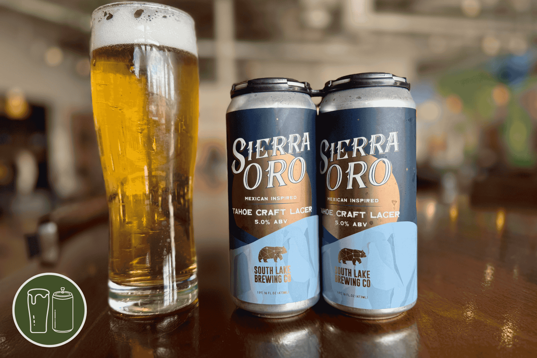 Pilner glass of Sierra Oro Mexican lager and a four pack of the same beer.