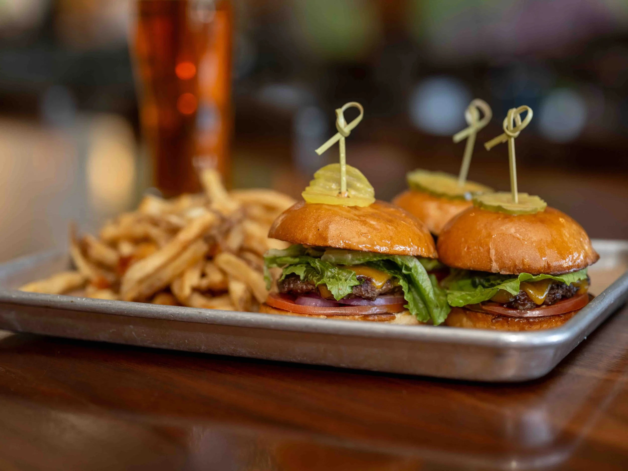 3 beef sliders on a plate with fries