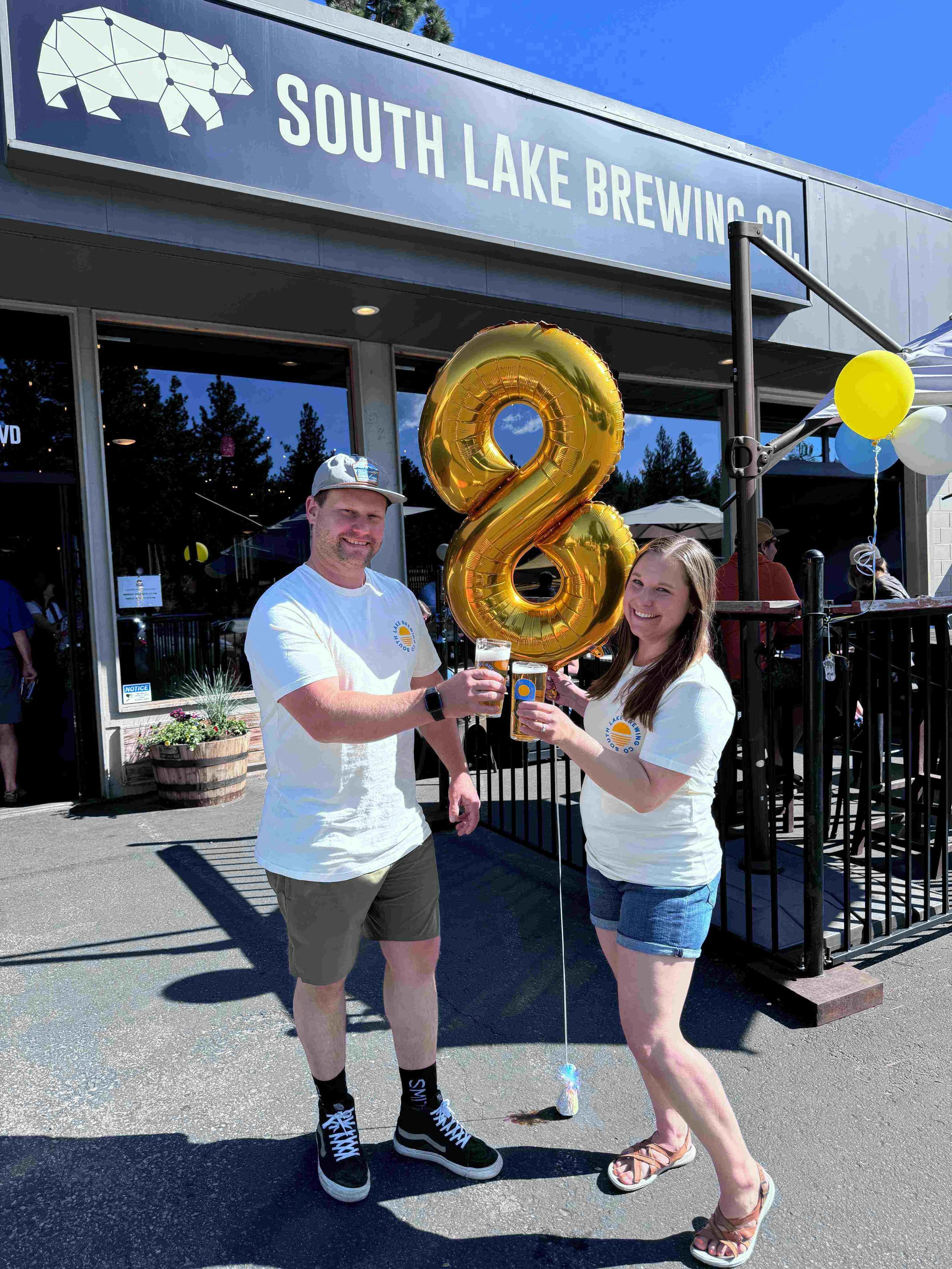 Chris & Nicole Smith smile with 8 gold balloon