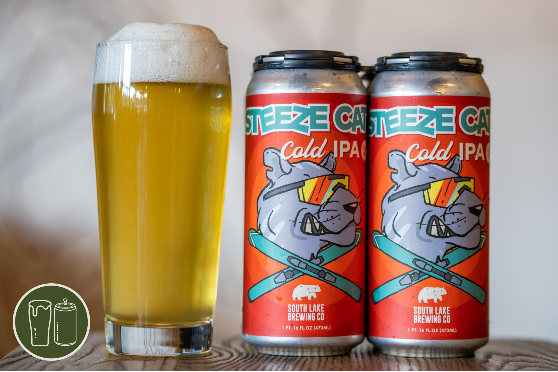 Four Pack of Steeze Cat next to a pint on a wooden stool.