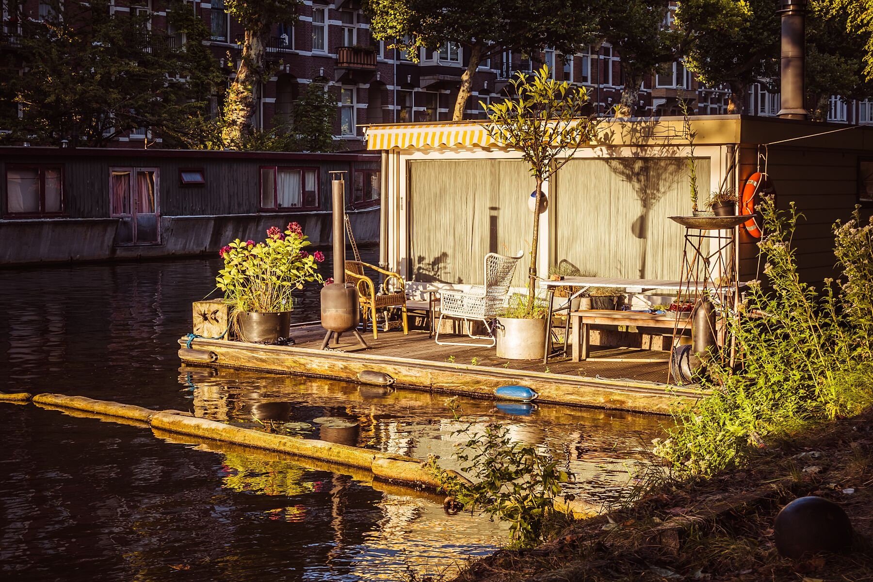 Amsterdam houseboat photography print showcasing Dutch canal life, featuring a charming floating home. Perfect for adding a touch of Netherlands culture to your home decor.