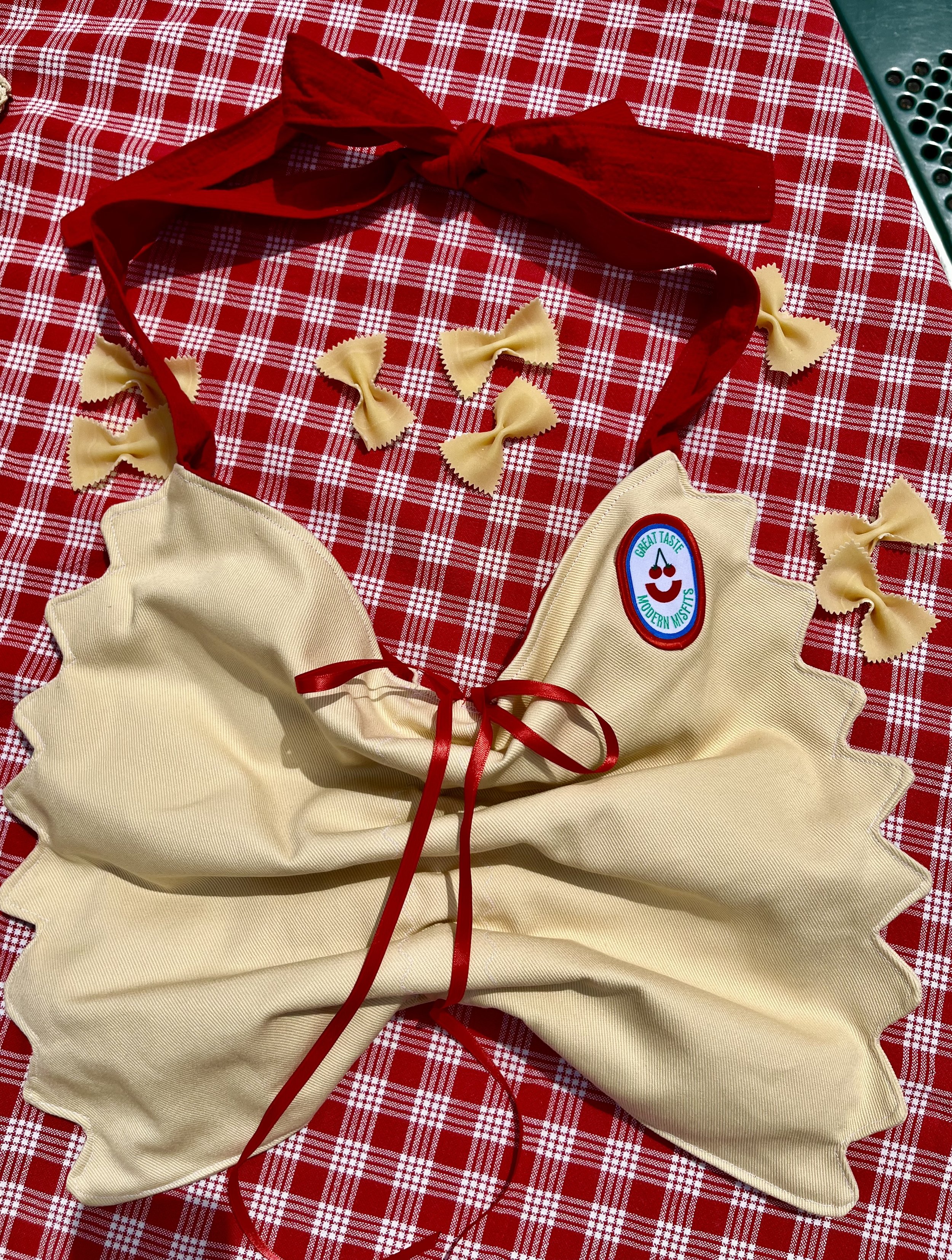 Bow tie noodle shaped bag on plaid background