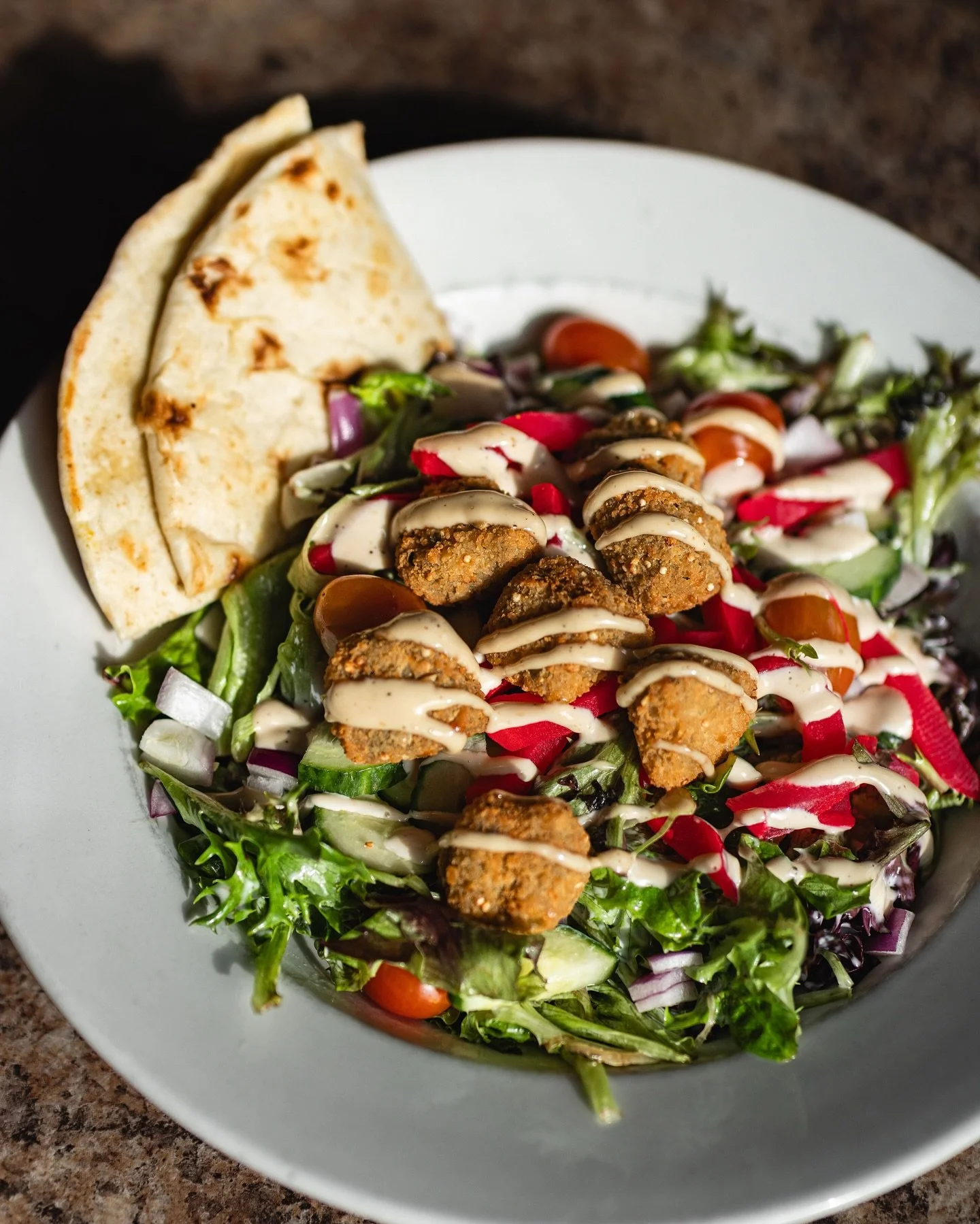 Fresh, vibrant, and full of flavour 🥗🌿

Our Falafel Salad brings together crispy falafel, fresh greens, cucumbers, onions, tomato, and pickled turnip, all finished with our dill pickle sauce and served with warm pita. Light, satisfying, and perfect