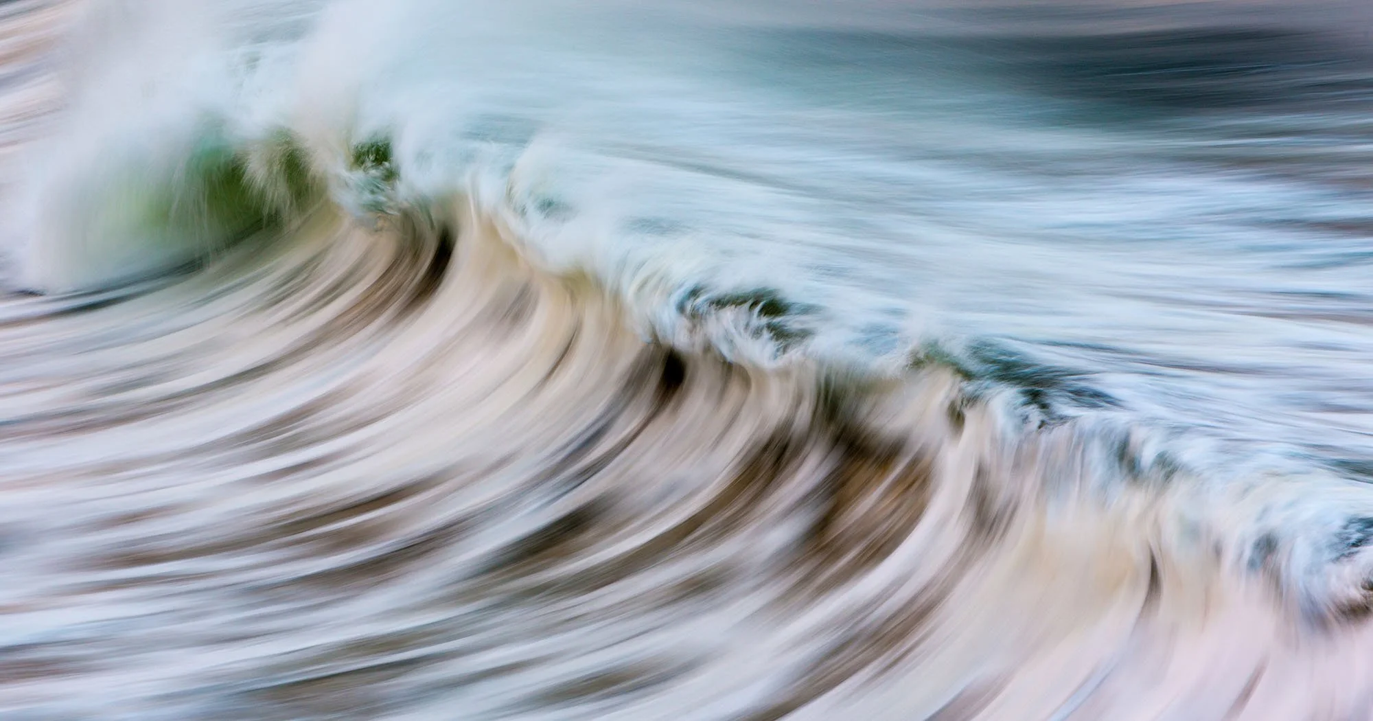 Blurred image of ocean waves crashing and swirling