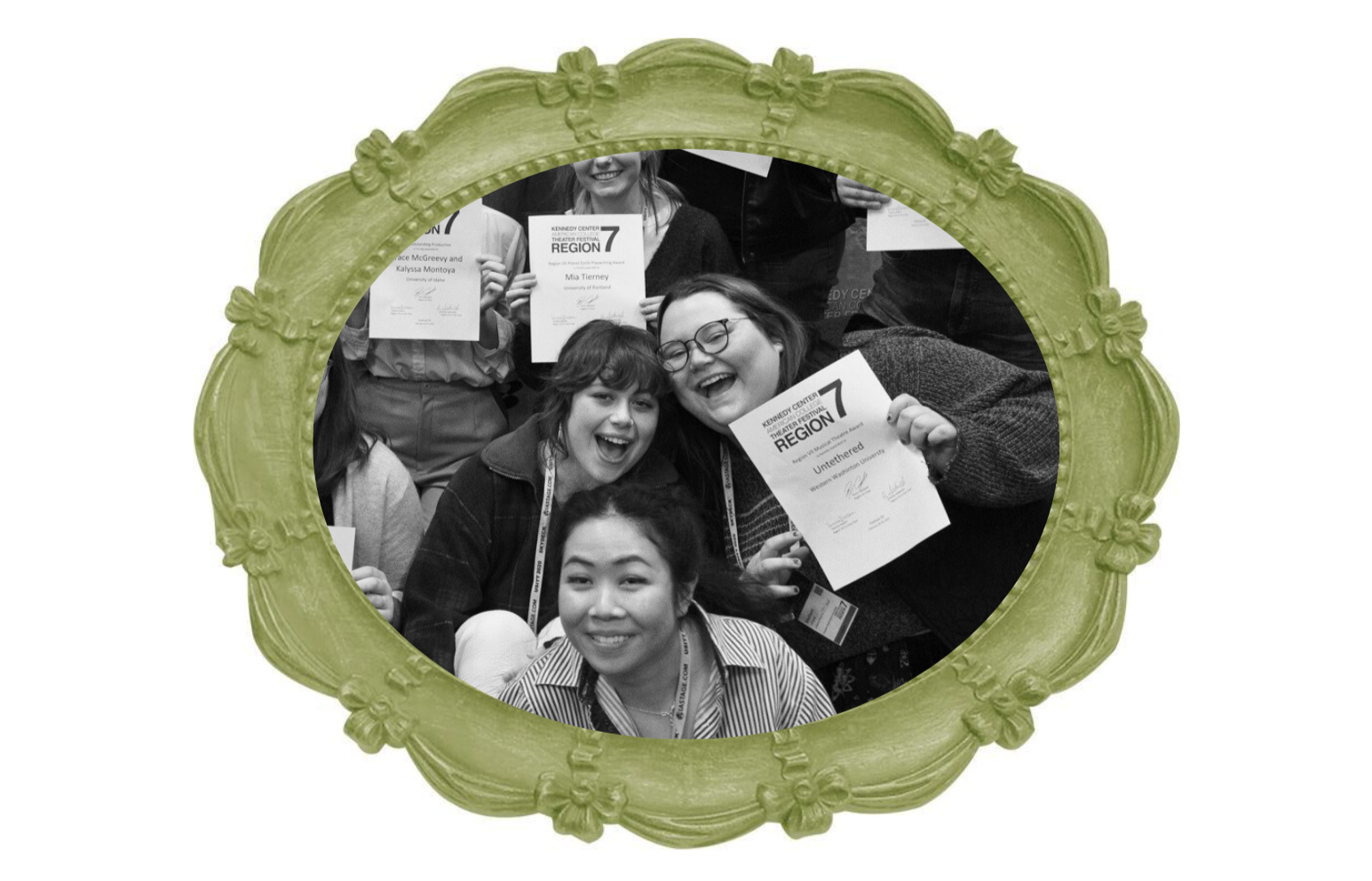 Group of smiling women holding certificates at an event, seen through a decorative green picture frame