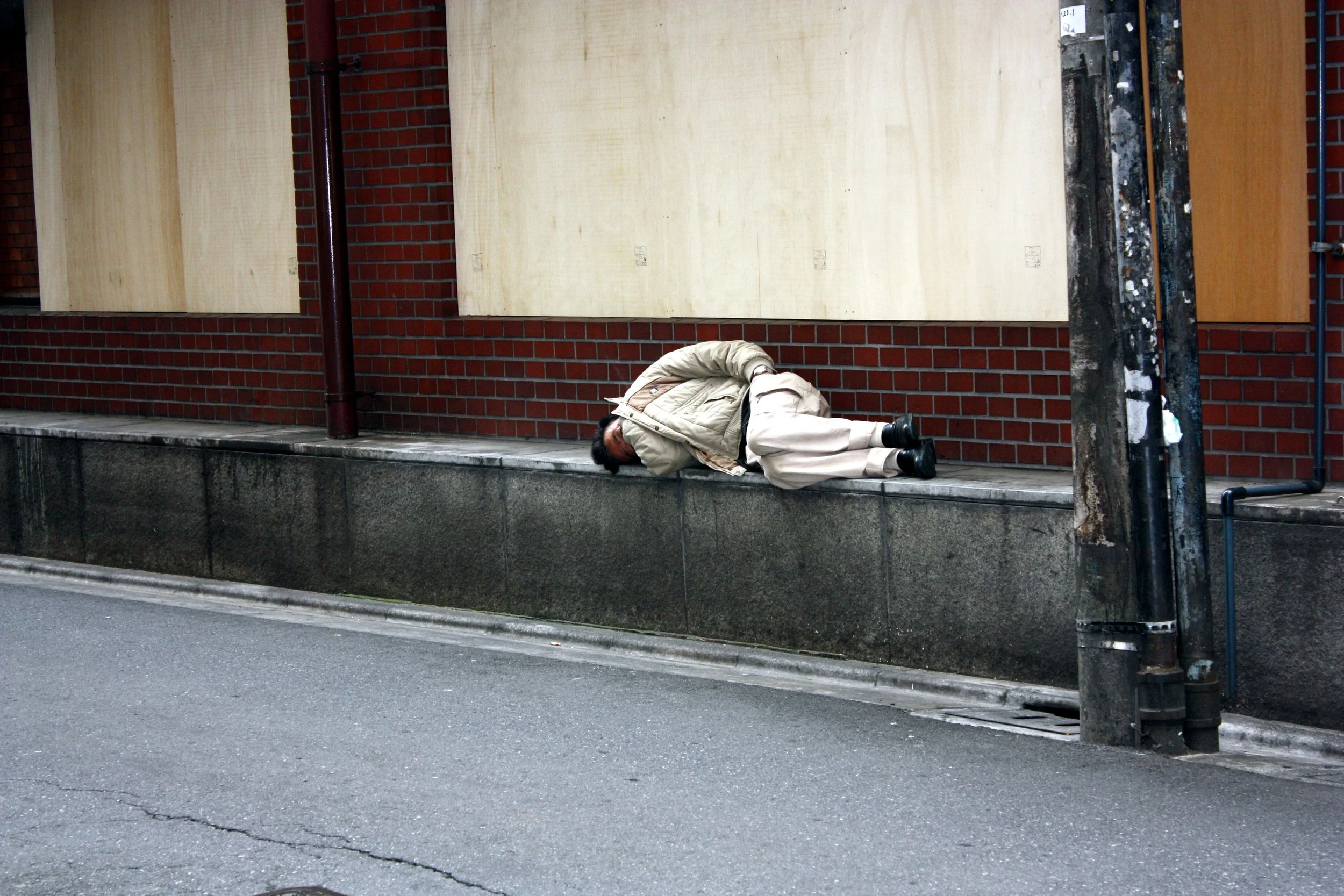 People sleeping on stone ledge