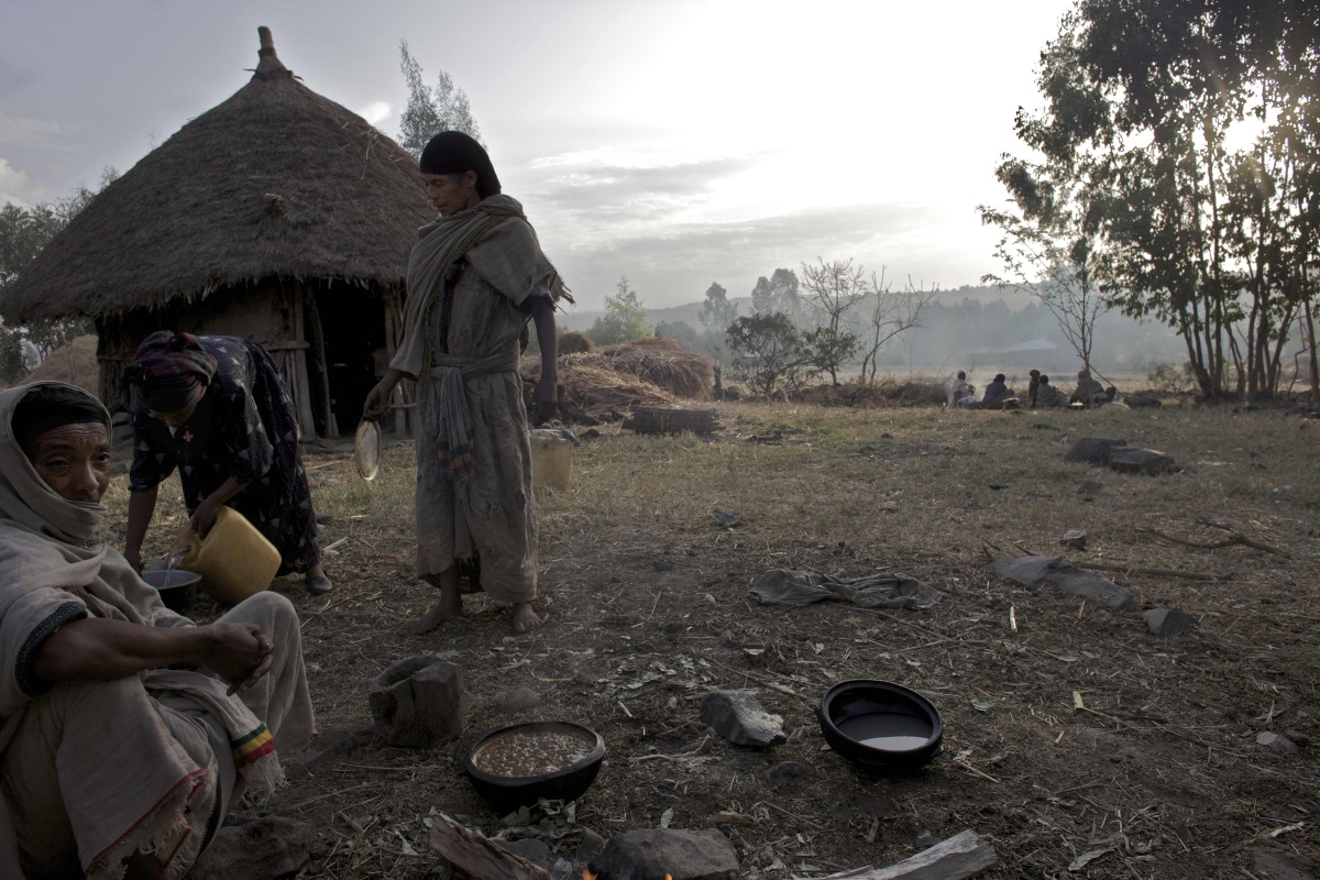  Relatives of Etinesh, 11 years old, and Torokan, 8 years old, who will be sold into marriage that day, prepare meals to be served during the marriage celebration at dawn in a village in the Northern Amhara region of Ethiopia. 