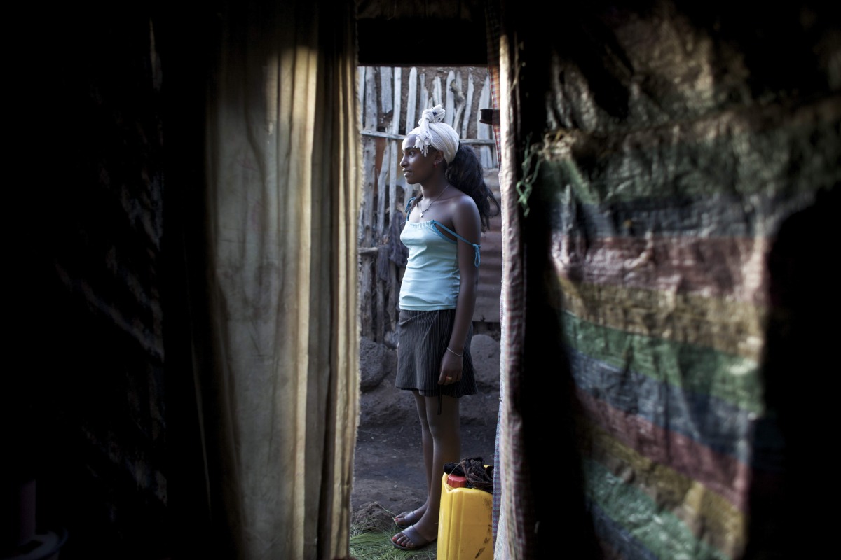  Agare’ stands outside the shack where she works as a sex worker while waiting for clients in the center of the city of Bahir Dar, a commercial hub in the Northern Amhara region of Ethiopia.&nbsp; 