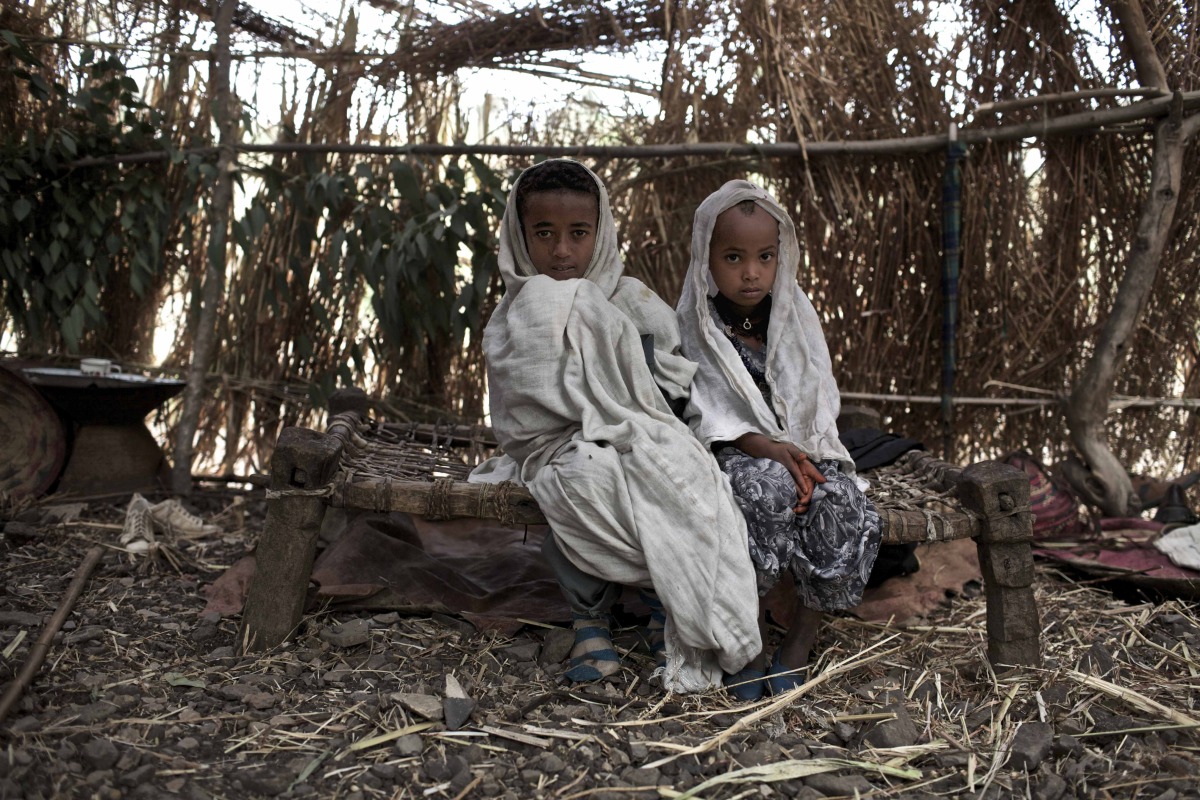  Ambaun, 9 years old, and Deghe, 7 years old, sit in their matrimonial tent before their wedding celebration’s commence in a village in the Northern Amhara region. 